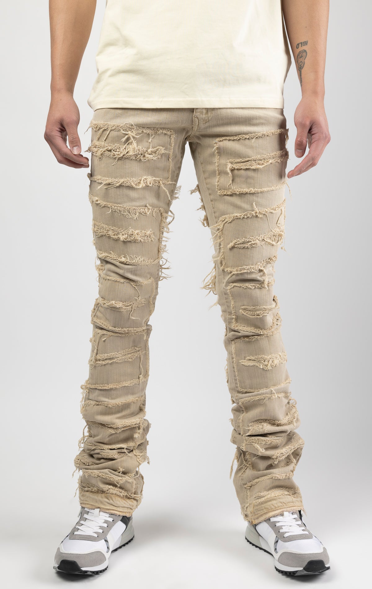 Cream bold, risk-taking flare pants feature a regular rise and extended length for maximum stacks. With a unique heavy wash and rip and repair design, complete with patches and abrasions, these skinny fit jeans are ready for adventure. Made from 98% cotto