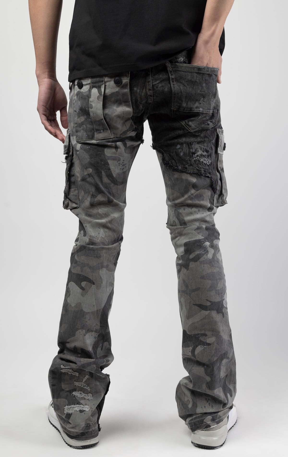 Black camo Extended length flare pant with a regular rise for maximum stacks. Skinny fit with hand-smearing and speckled paint splatter throughout. Rip and repair detailing, accompanied by cut & sewn woodland camouflage twill patches. Stitching repairs an