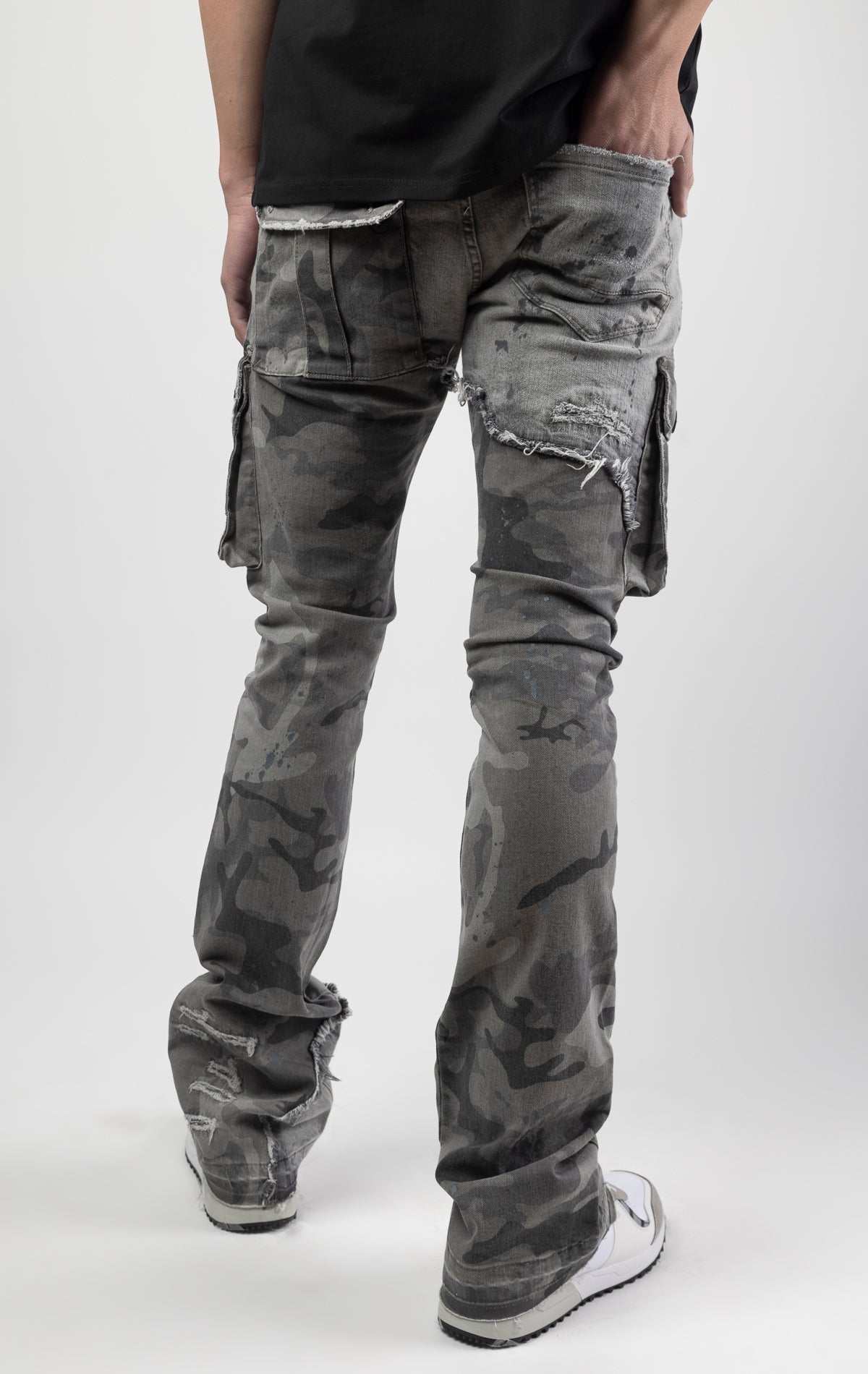 Overcast camo extended length flare pant with a regular rise for maximum stacks. Skinny fit with hand-smearing and speckled paint splatter throughout. Rip and repair detailing, accompanied by cut & sewn woodland camouflage twill patches. Stitching repairs