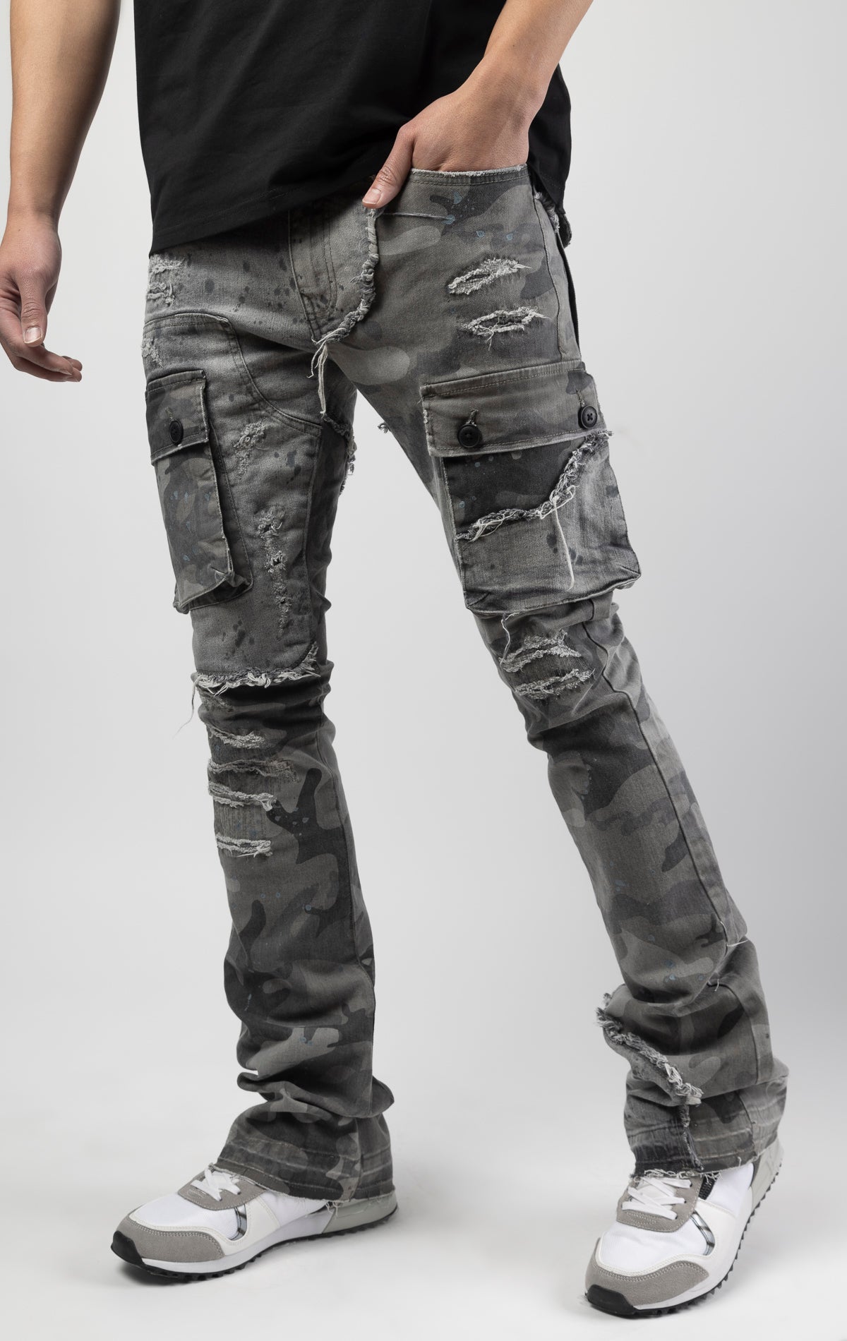 Overcast camo extended length flare pant with a regular rise for maximum stacks. Skinny fit with hand-smearing and speckled paint splatter throughout. Rip and repair detailing, accompanied by cut & sewn woodland camouflage twill patches. Stitching repairs