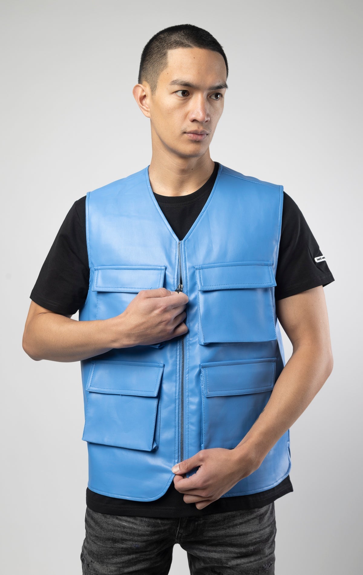 Blue faux leather cargo vest crafted from 100% PU, durable and cruelty-free. Featuring a 100% Polyester Linin.
