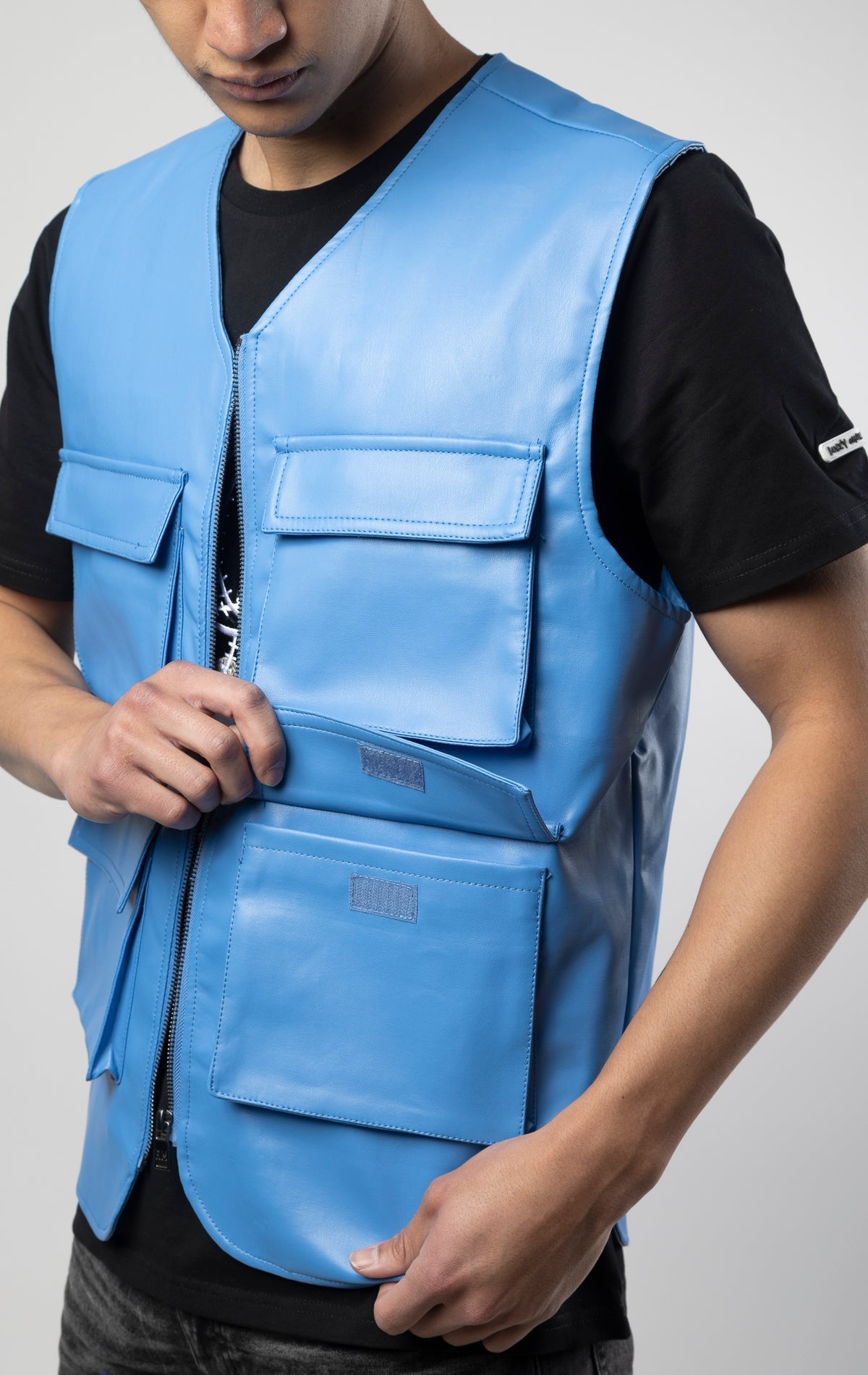 Blue faux leather cargo vest crafted from 100% PU, durable and cruelty-free. Featuring a 100% Polyester Linin.