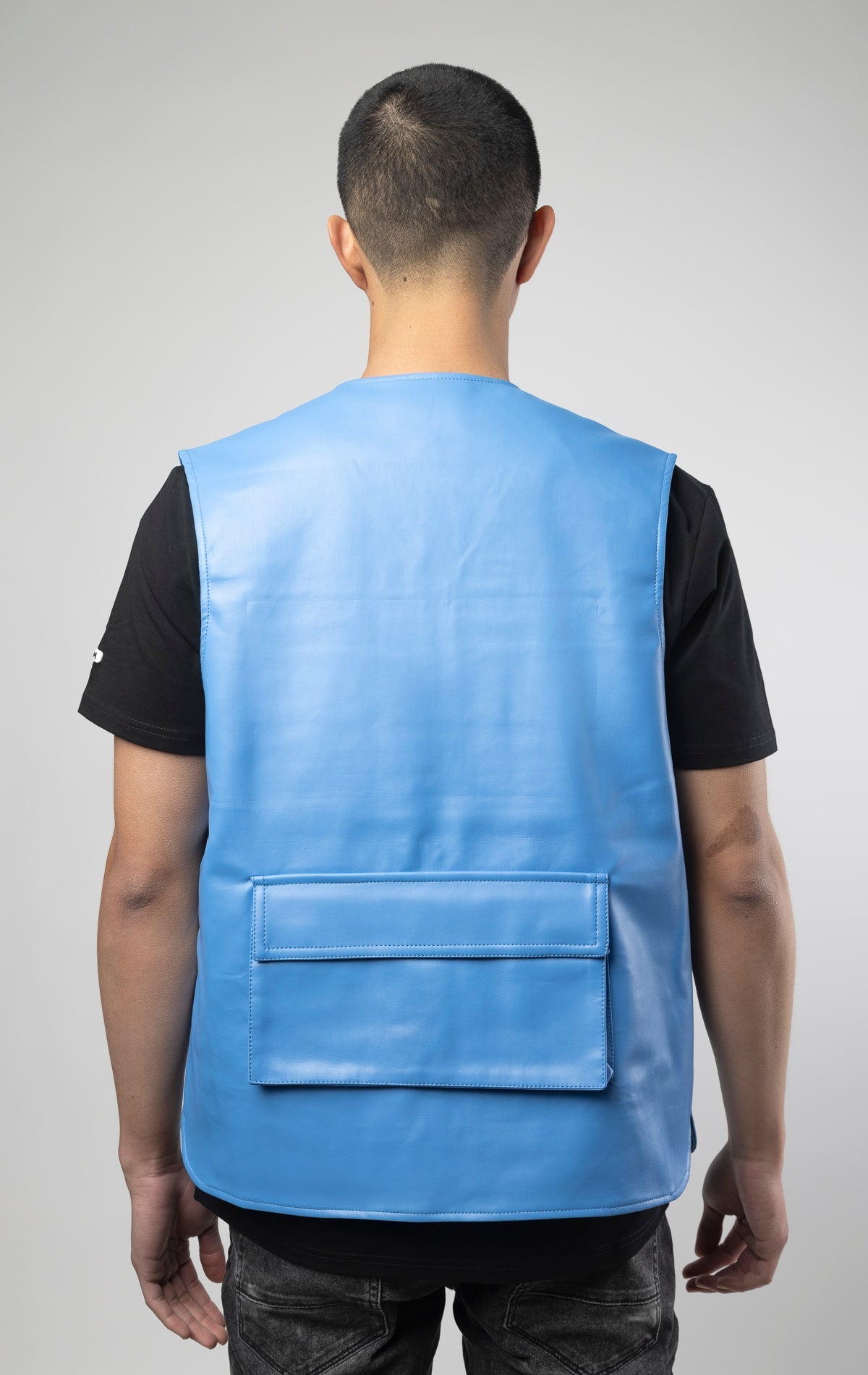 Blue faux leather cargo vest crafted from 100% PU, durable and cruelty-free. Featuring a 100% Polyester Linin.