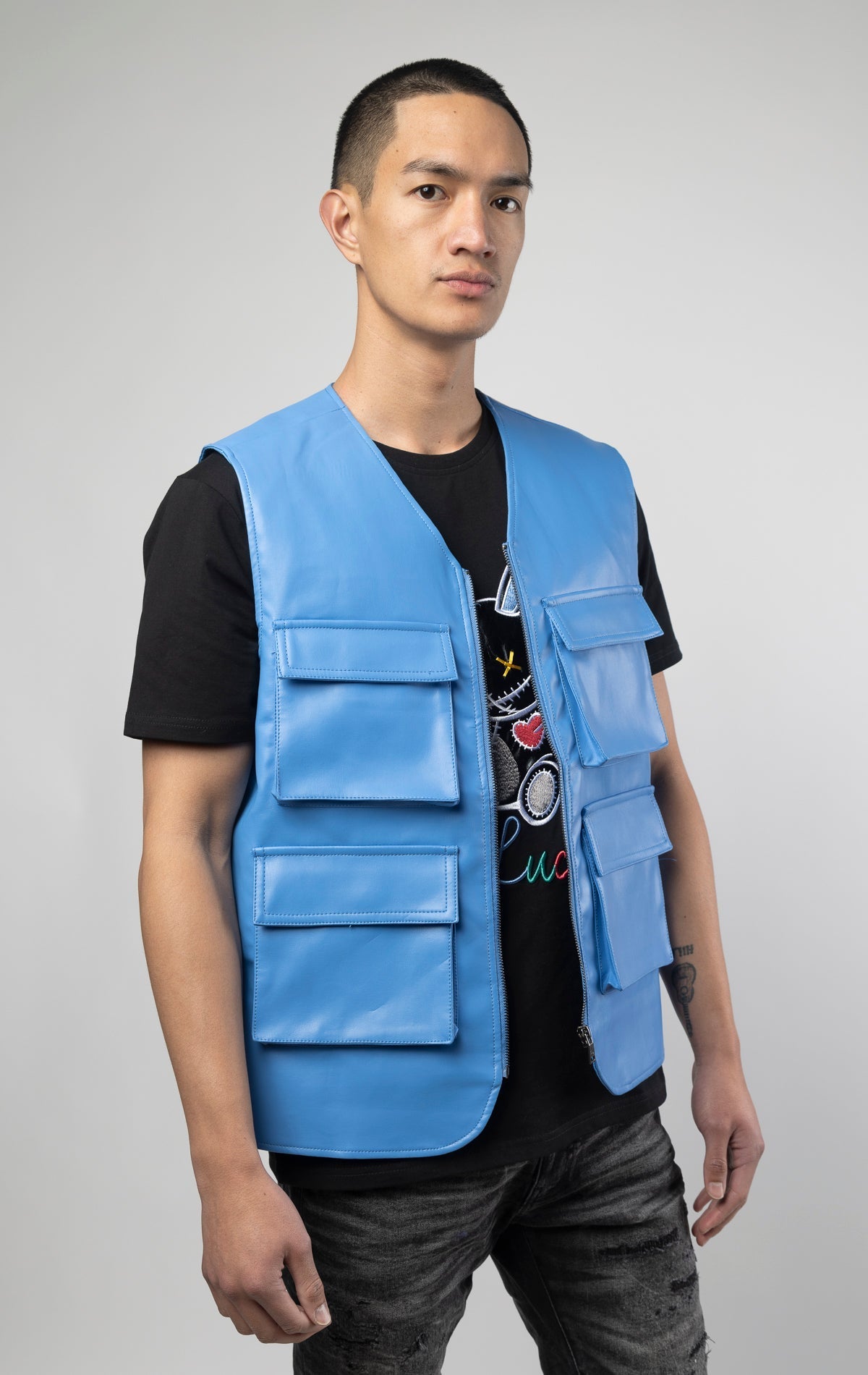 Blue faux leather cargo vest crafted from 100% PU, durable and cruelty-free. Featuring a 100% Polyester Linin.