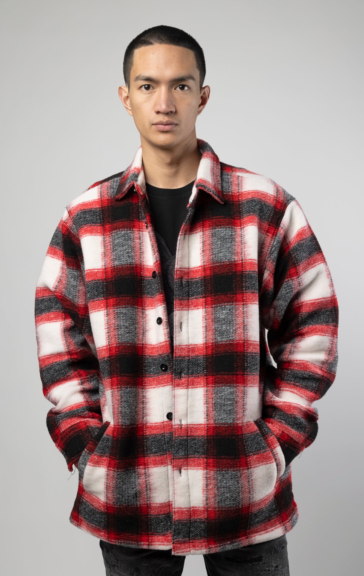 Model wearing Red, white and black oversized button up shirt made from soft, felted fabric