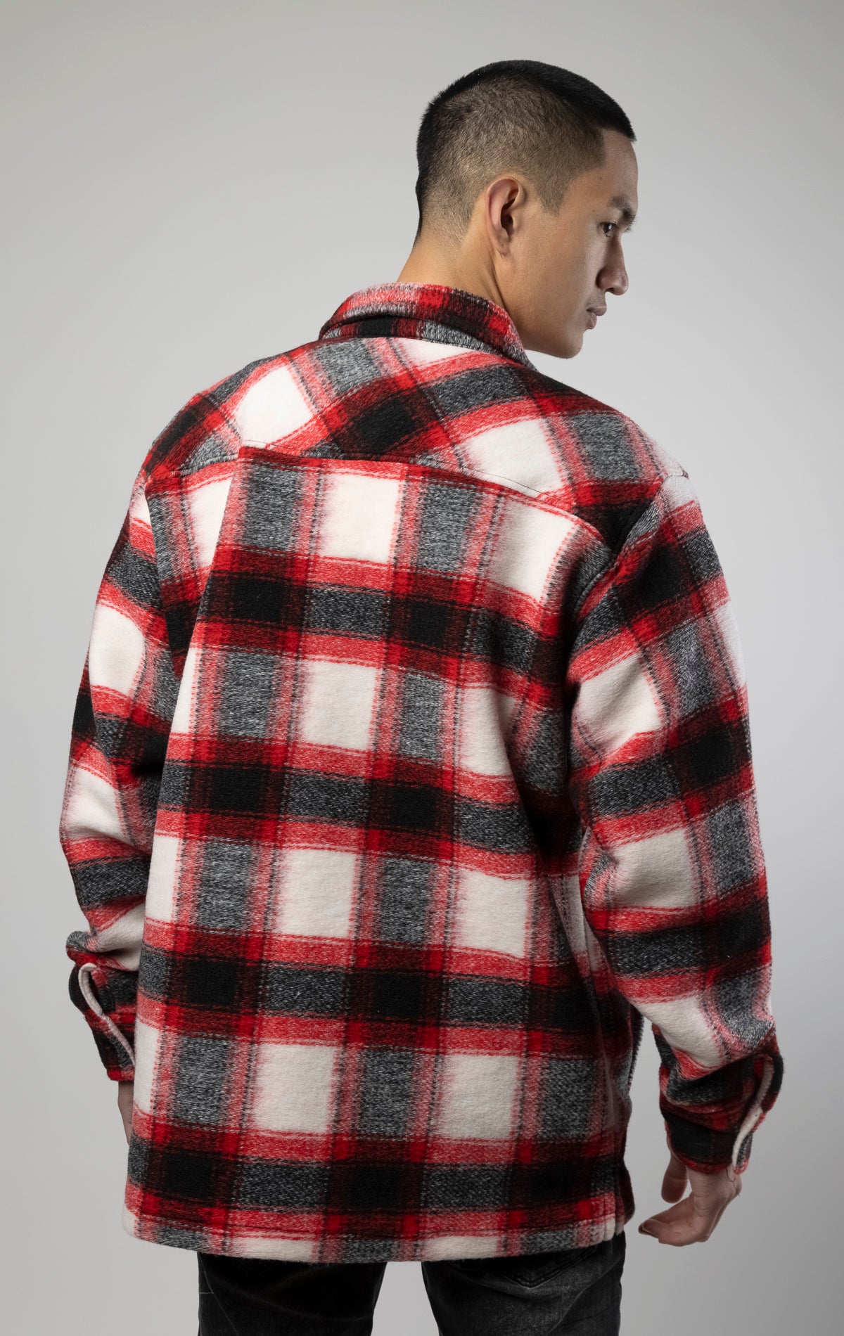 Model wearing Red, white and black oversized button up shirt made from soft, felted fabric