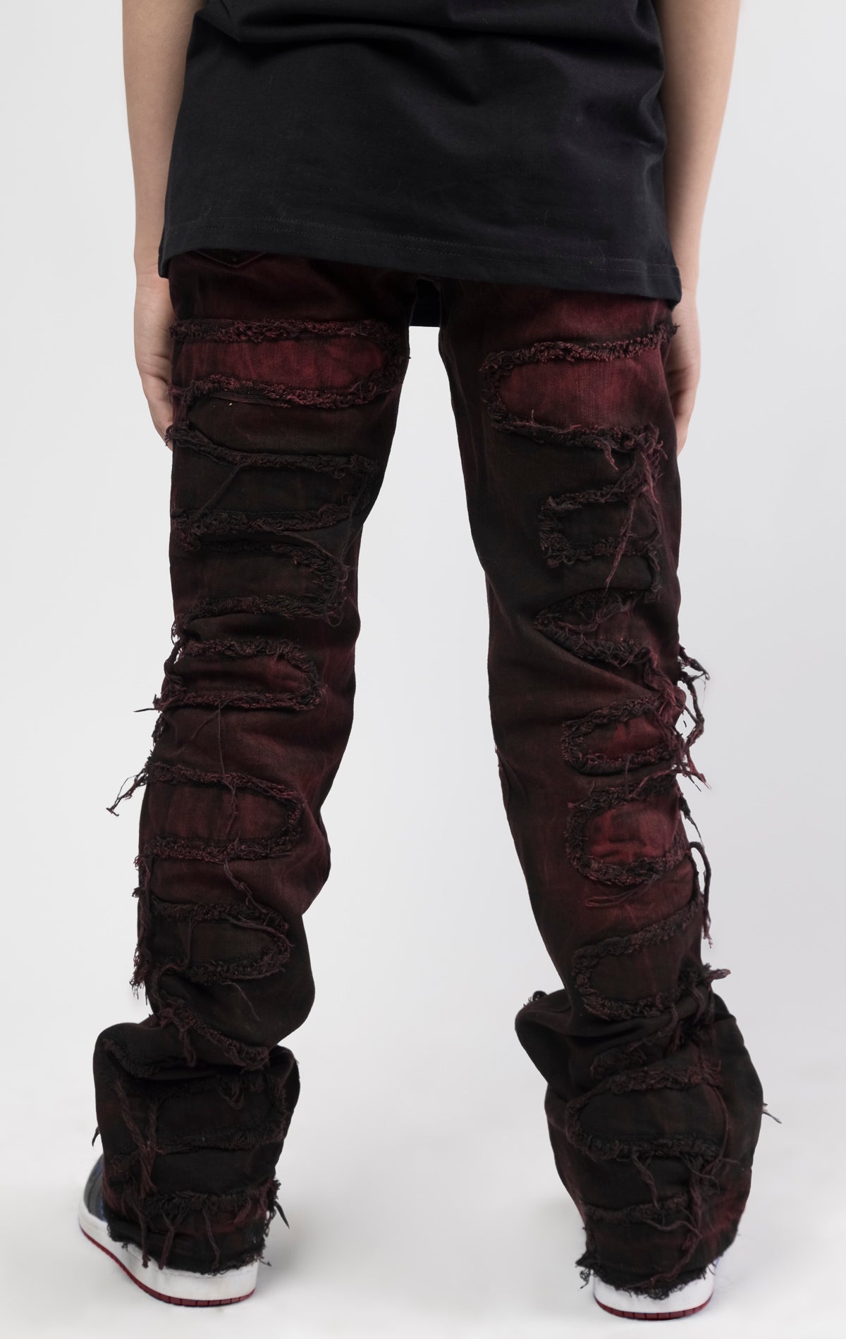 Skinny fit Regular rise denim with extended length for maximum stacks. Magma ombre wash with rip and repair design featuring self fabric backing. Patches and abrasions throughout for a trendy and edgy look.