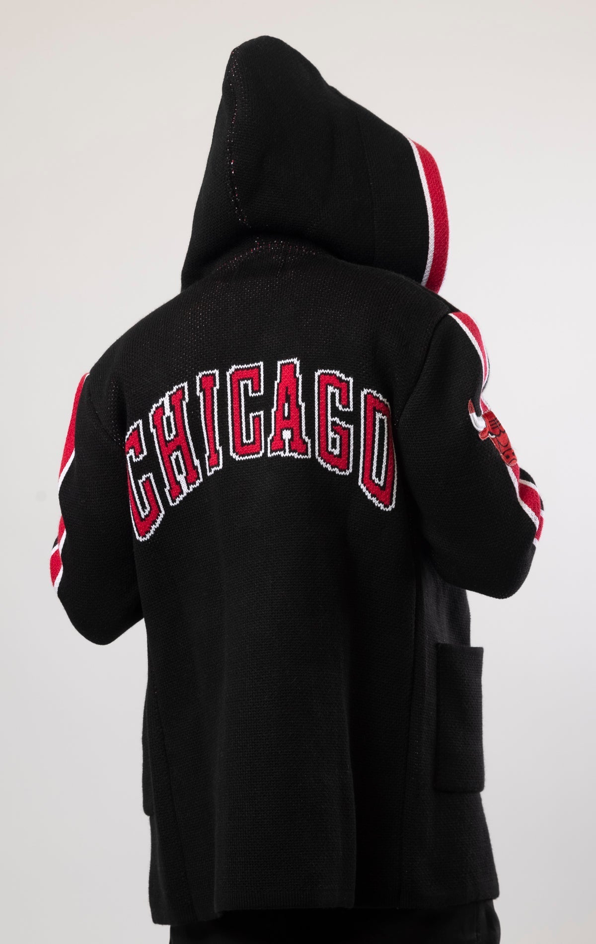 Upgrade your game day look with this Chicago Bulls Cardigan Sweater. This cozy jacket is designed with a stylish three-quarter length and boasts bold team branding on the front, back, and sleeve. Complete with a full-zip closure, attached hood, and front