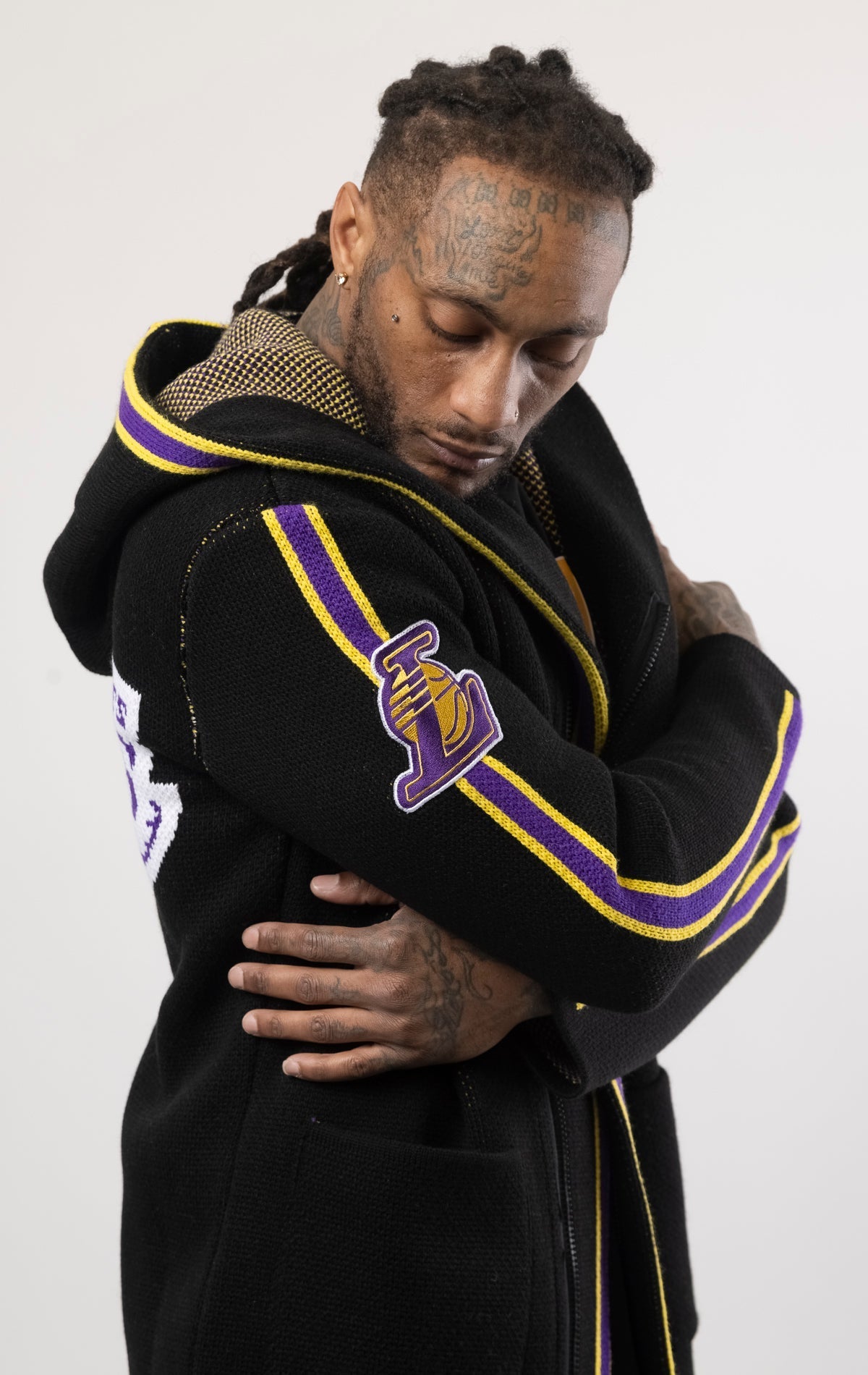 black LA LAKERS Cardigan Sweater. This cozy jacket is designed with a stylish three-quarter length and boasts bold team branding on the front, back, and sleeve. Complete with a full-zip closure, attached hood, and front pockets, this knit sweater offers b