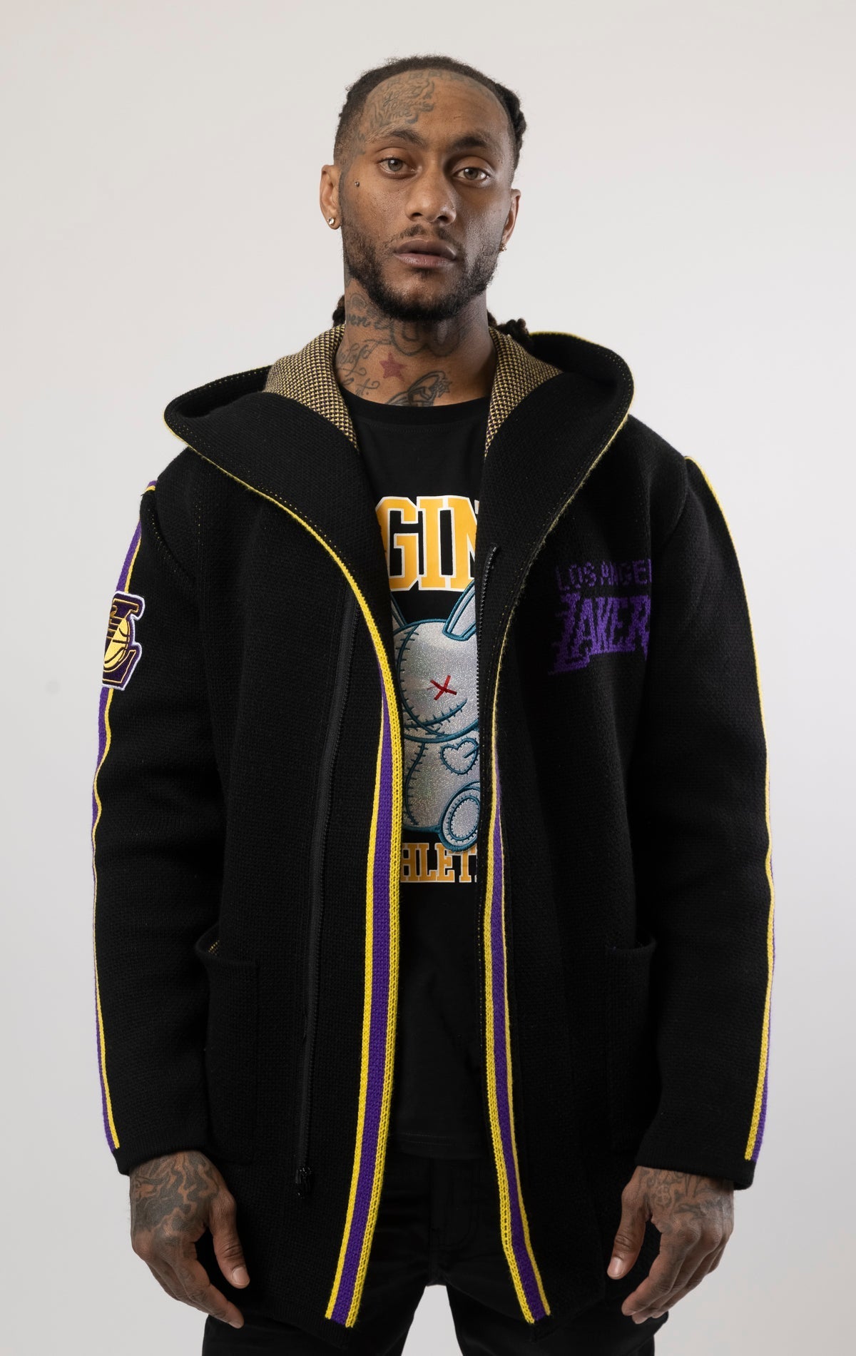 black LA LAKERS Cardigan Sweater. This cozy jacket is designed with a stylish three-quarter length and boasts bold team branding on the front, back, and sleeve. Complete with a full-zip closure, attached hood, and front pockets, this knit sweater offers b