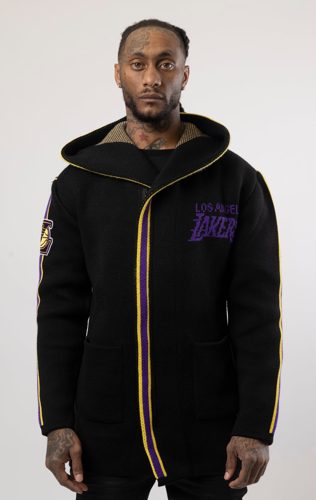 black LA LAKERS Cardigan Sweater. This cozy jacket is designed with a stylish three-quarter length and boasts bold team branding on the front, back, and sleeve. Complete with a full-zip closure, attached hood, and front pockets, this knit sweater offers b