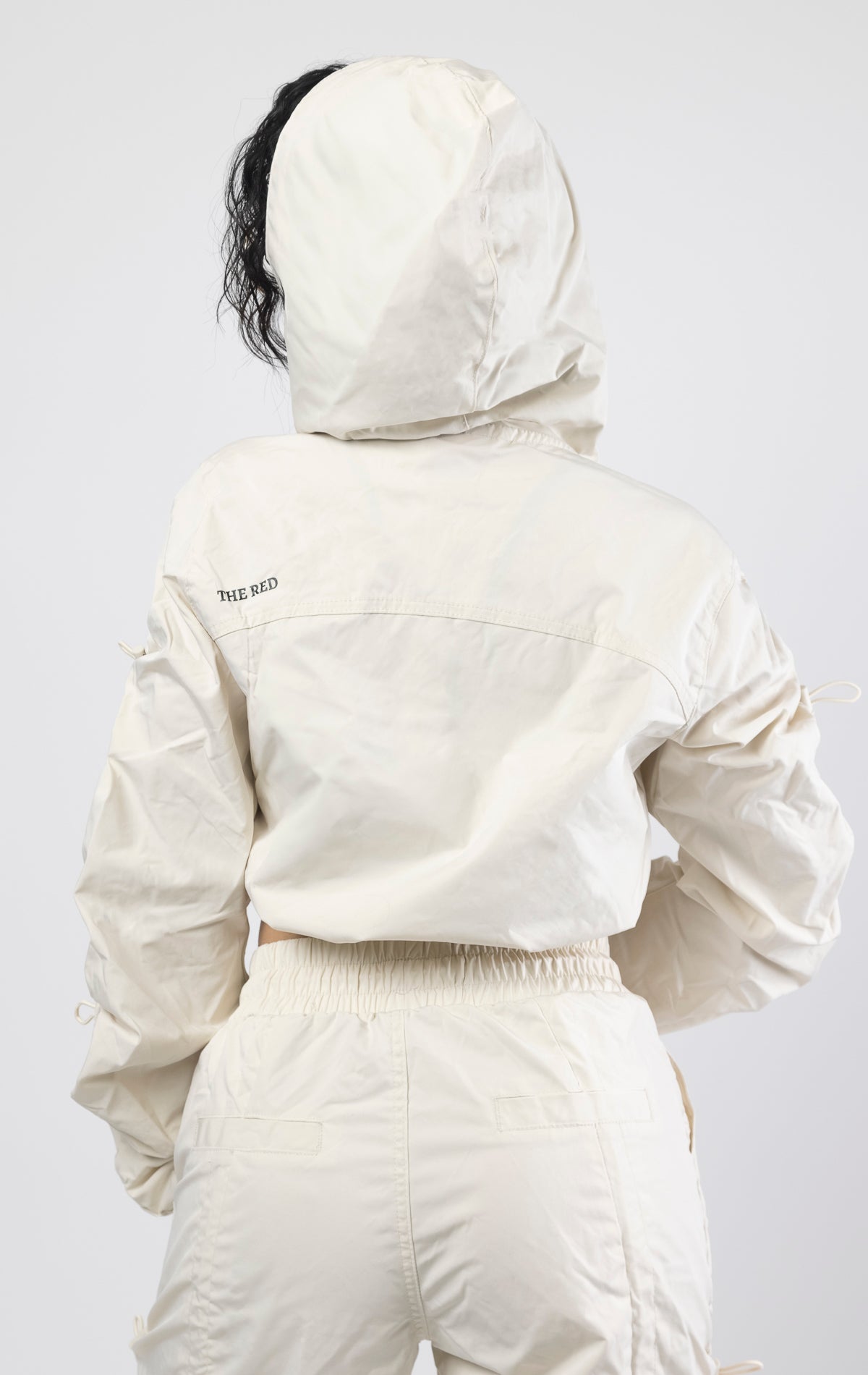 Oatmeal Cropped windbreaker full zip jacket. Fit: Carter metal eyelets3-D cargo pocket with self strap, adjustable bottom opening, and cuffed hem