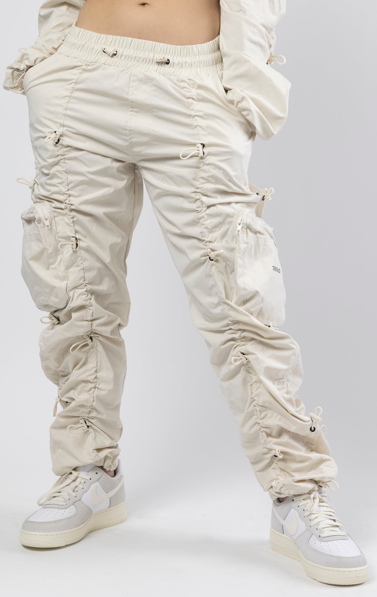 Oatmeal coral multi-bungee jogger featuring a Brook fit, snap buttons, an adjustable waist and wide pockets.