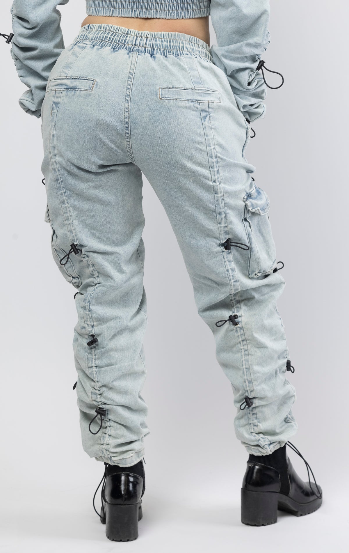 multi-bungee denim jogger features an adjustable waist and wide pockets