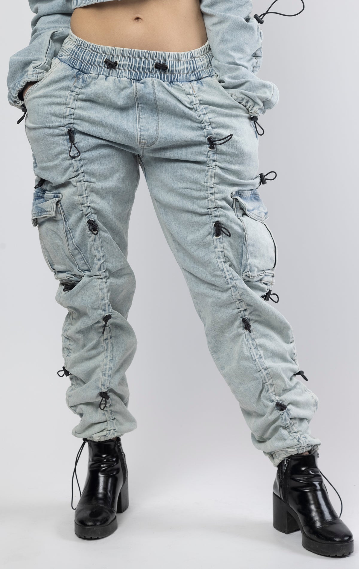 multi-bungee denim jogger features an adjustable waist and wide pockets