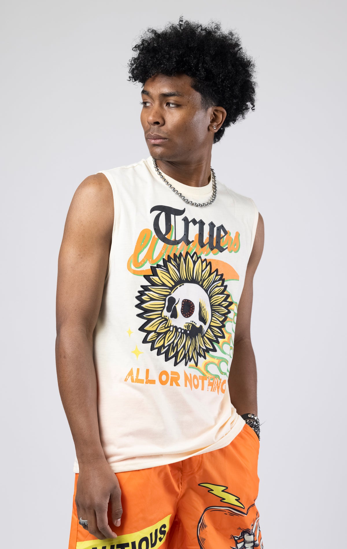 Creme Sleeveless crew neck tank top with a printed graphic.