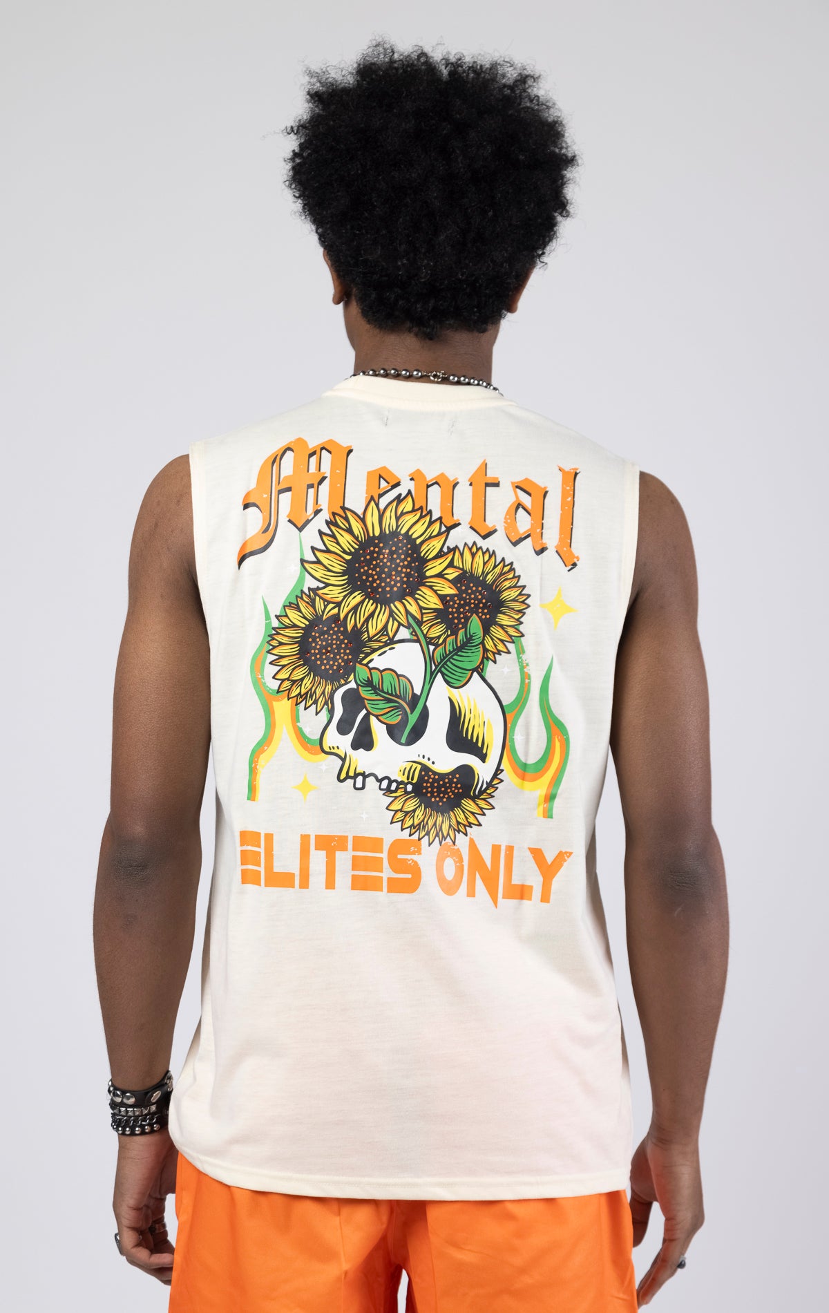 Creme Sleeveless crew neck tank top with a printed graphic.