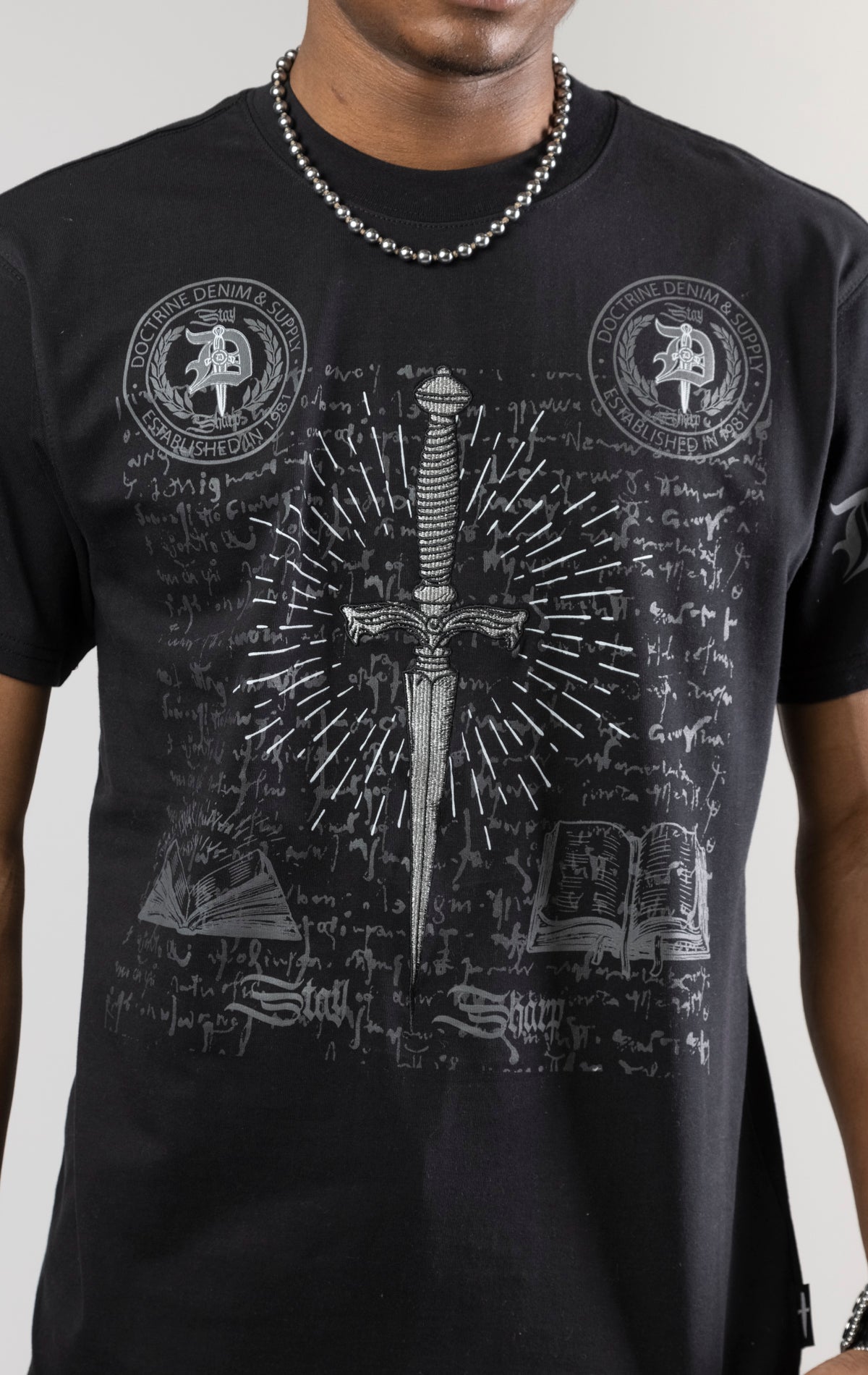 black CORE DAGGER vintage graphic t-shirt. The shirt is made from 100% cotton with a vintage wash and features a high-definition digital graphic on the front.