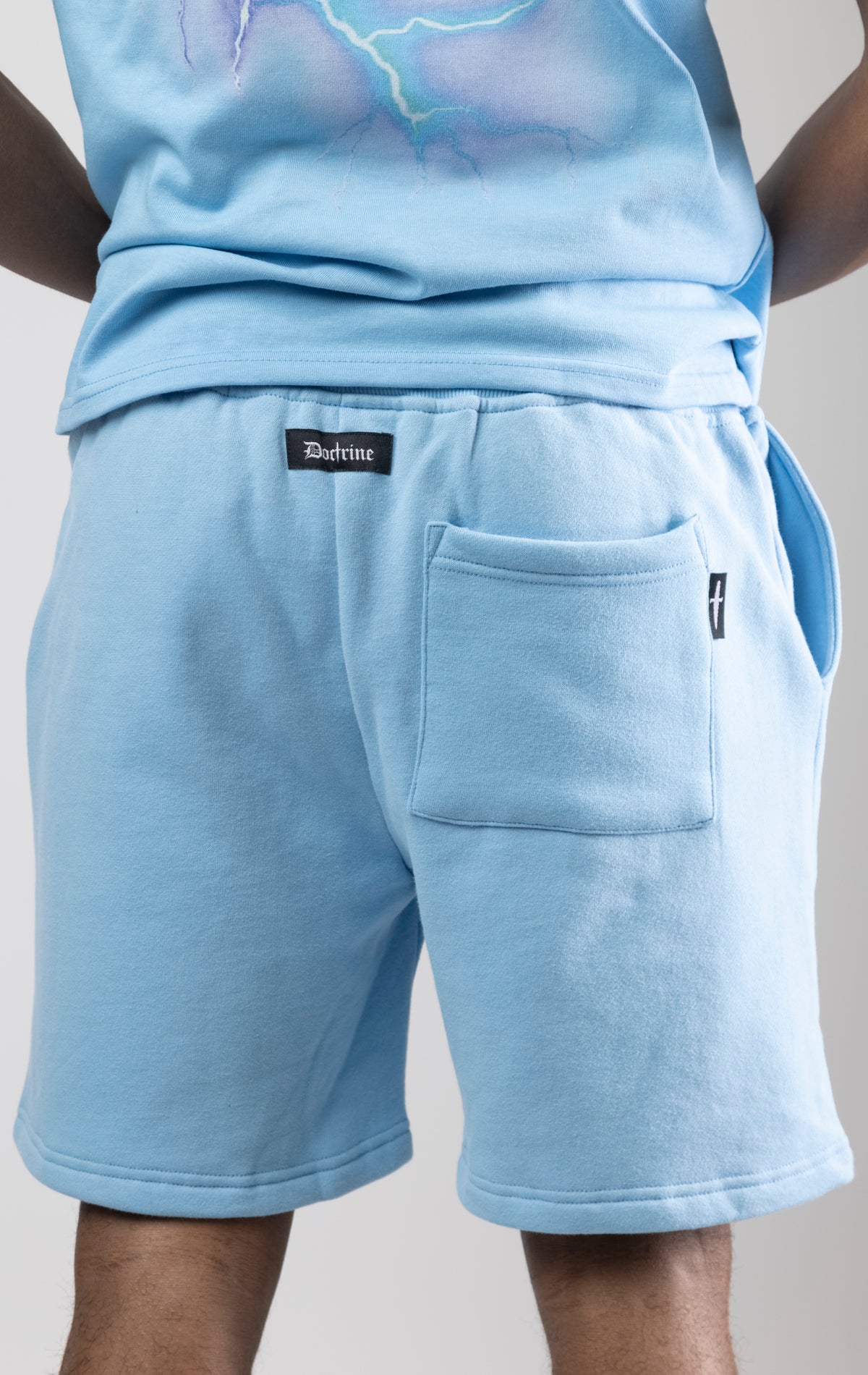Sky blue fleece shorts with a digital lightning print running down the legs.
