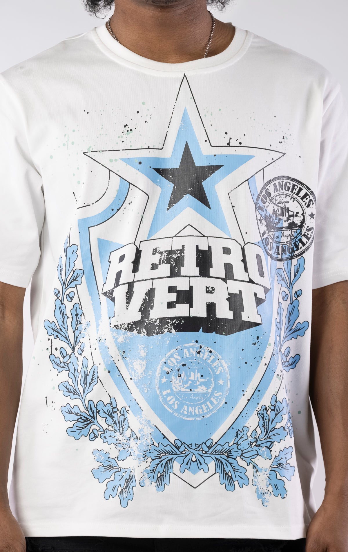 White organic cotton t-shirt with front and back graphics, ribbed collar, and slightly oversized fit.