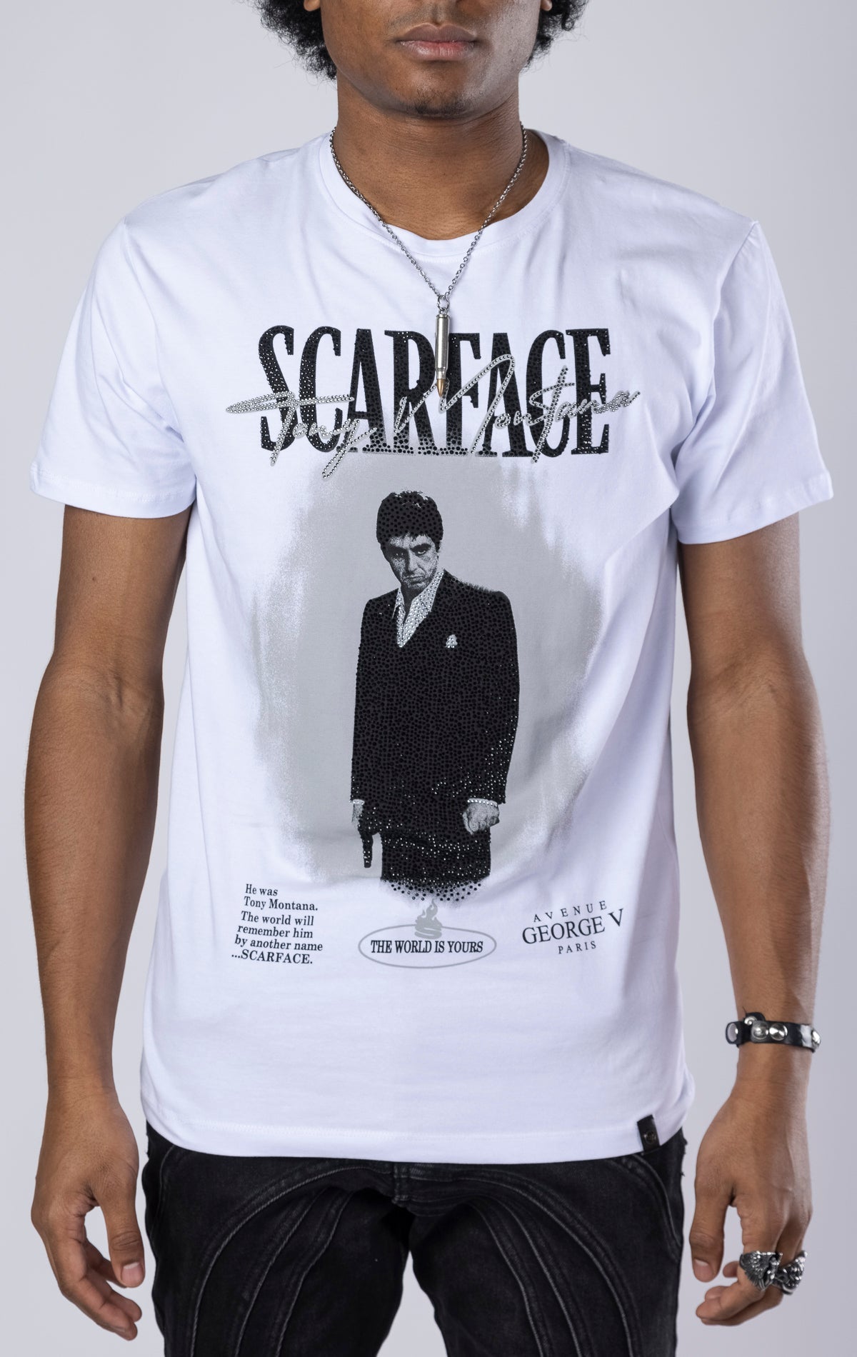 White Scarface Crewneck Tee. Features a crewneck, short sleeves, and a bold Scarface graphic. Made from a blend of 95% cotton and 5% lycra.