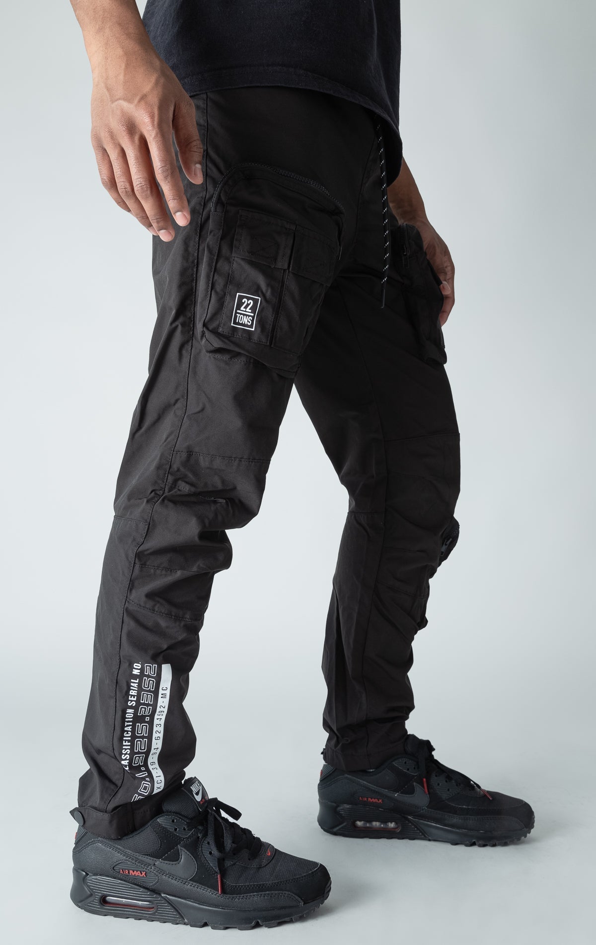 Black open bottom windbreaker utility joggers.