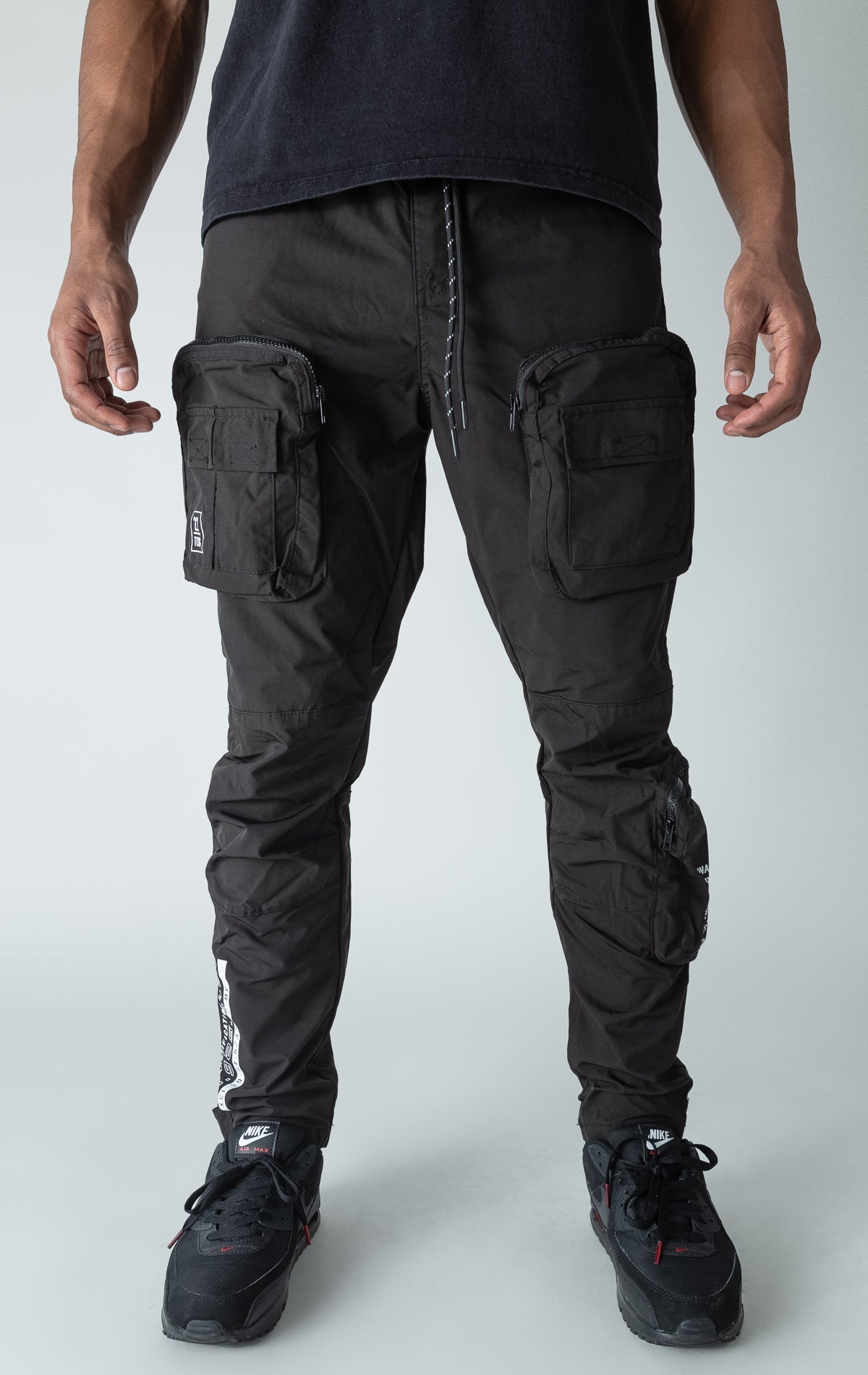 Black open bottom windbreaker utility joggers.