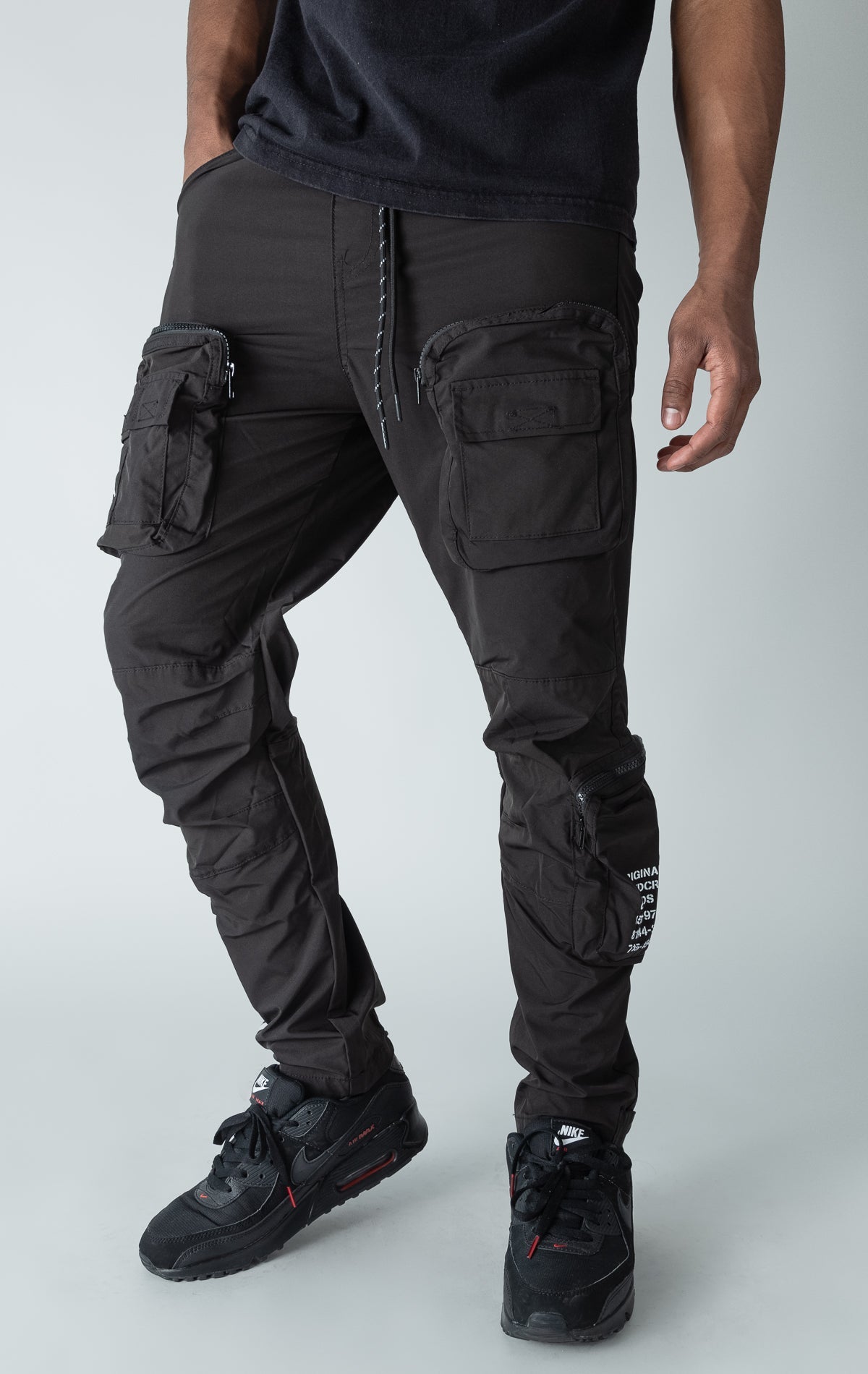 Black open bottom windbreaker utility joggers.