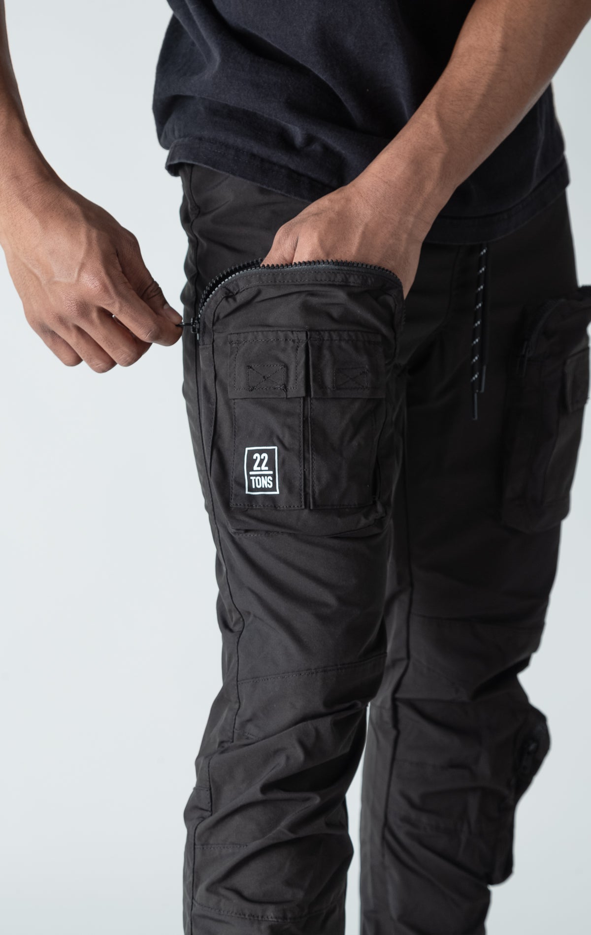 Black open bottom windbreaker utility joggers.