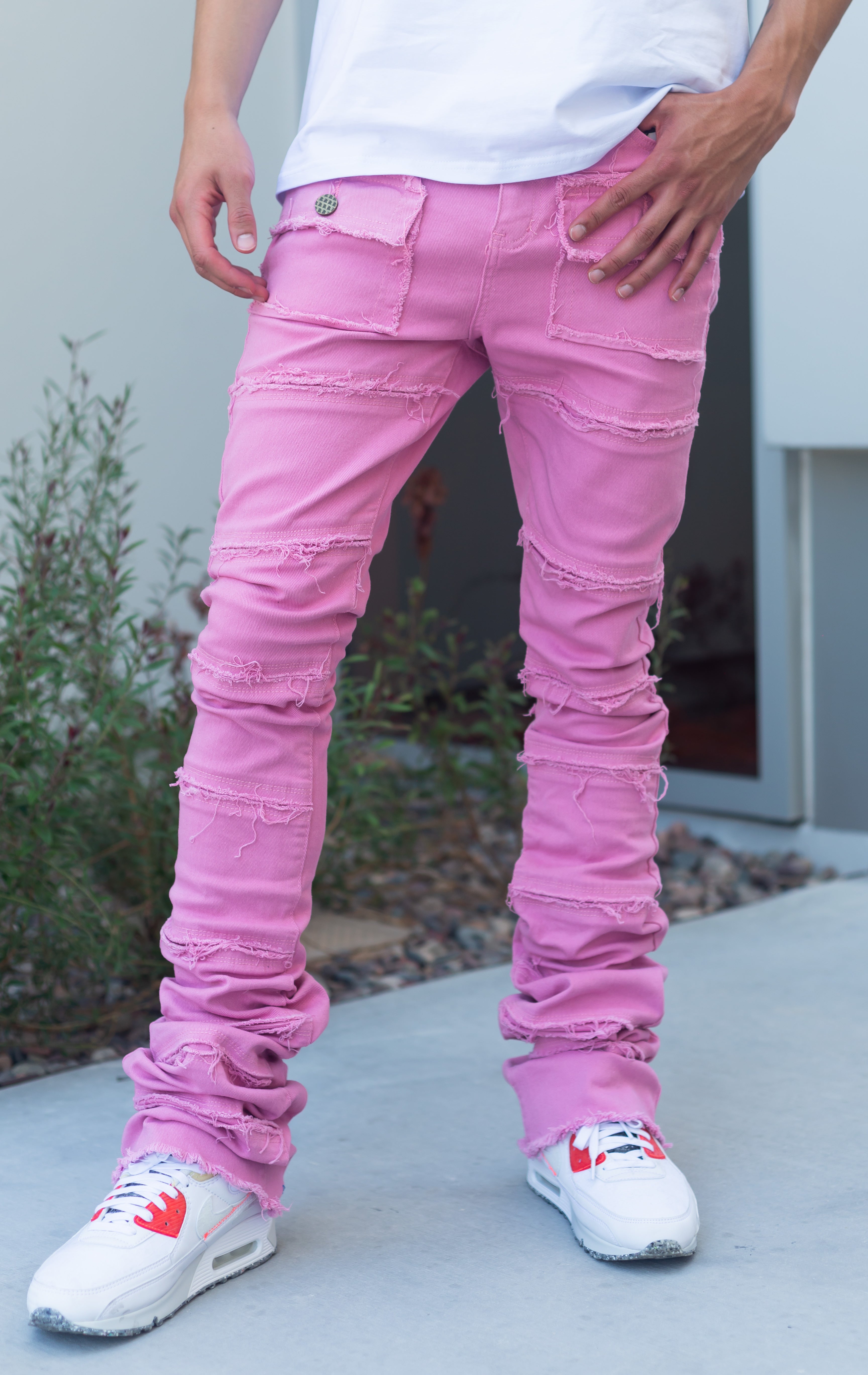 Pink super stacked denim. Featuring 7-pocket design, button utility pockets, exposed stitching, frayed hems, super stacked construction, flare leg openings, and impressive 46.5" seams.