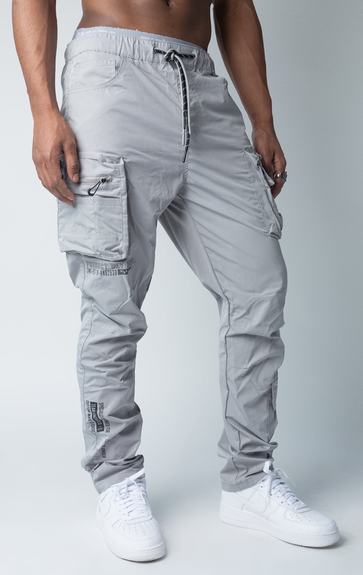 Grey windbreaker utility pants, sleek fit with an open bottom jogger style