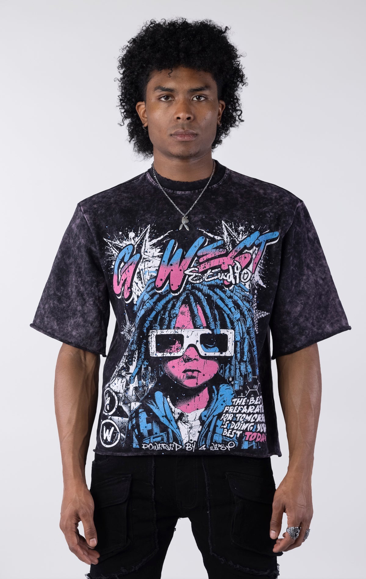 Washed black/purple oversized t-shirt featuring a large graphic of a figure with blue dreadlocks and white 3D glasses. The graphic includes the text "G-WEST Studios" and "THE BEST PREPARATION FOR TOMORROW IS DOING YOUR BEST TODAY!" accented with rhineston