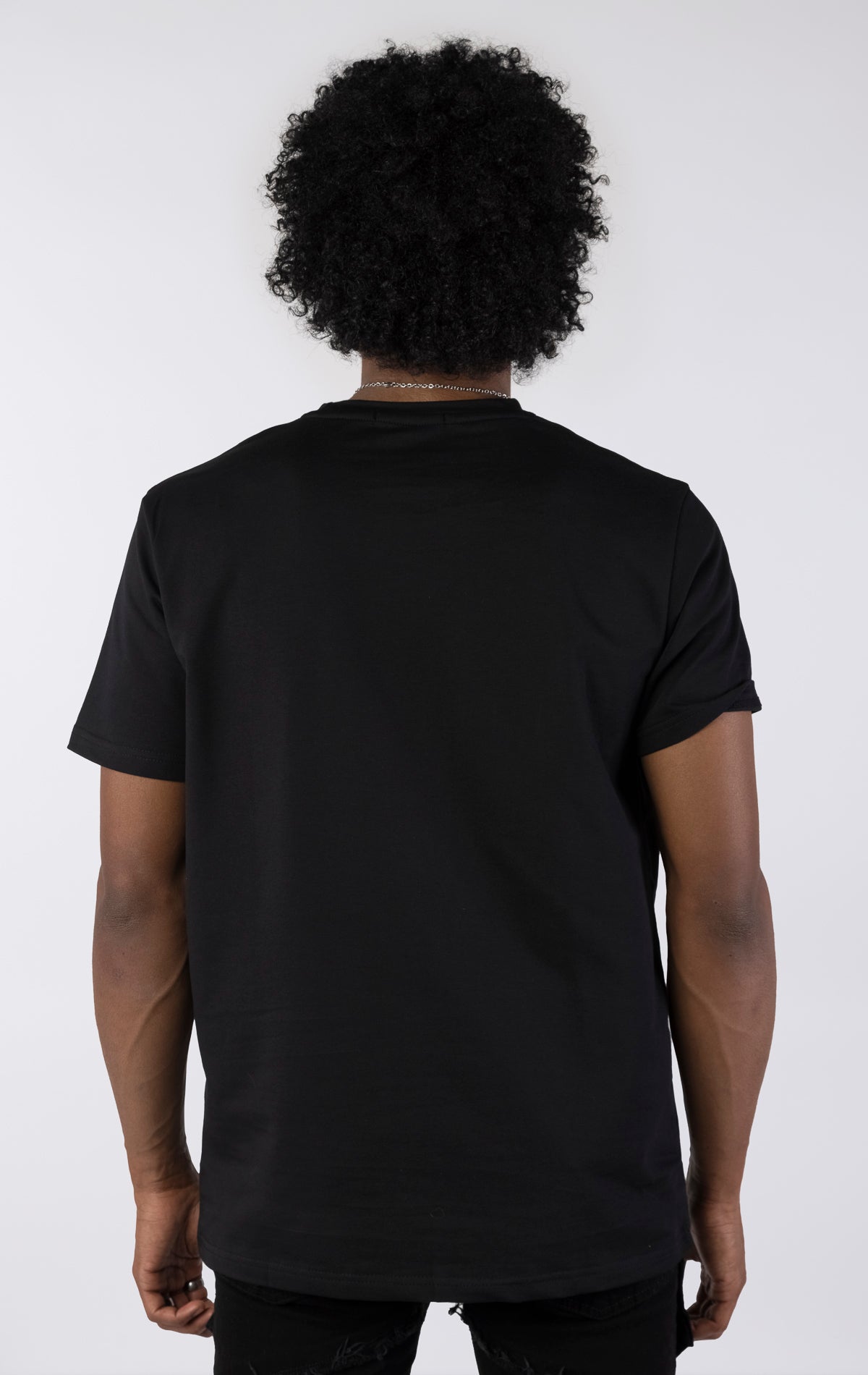 Person wearing a black t-shirt on a white background