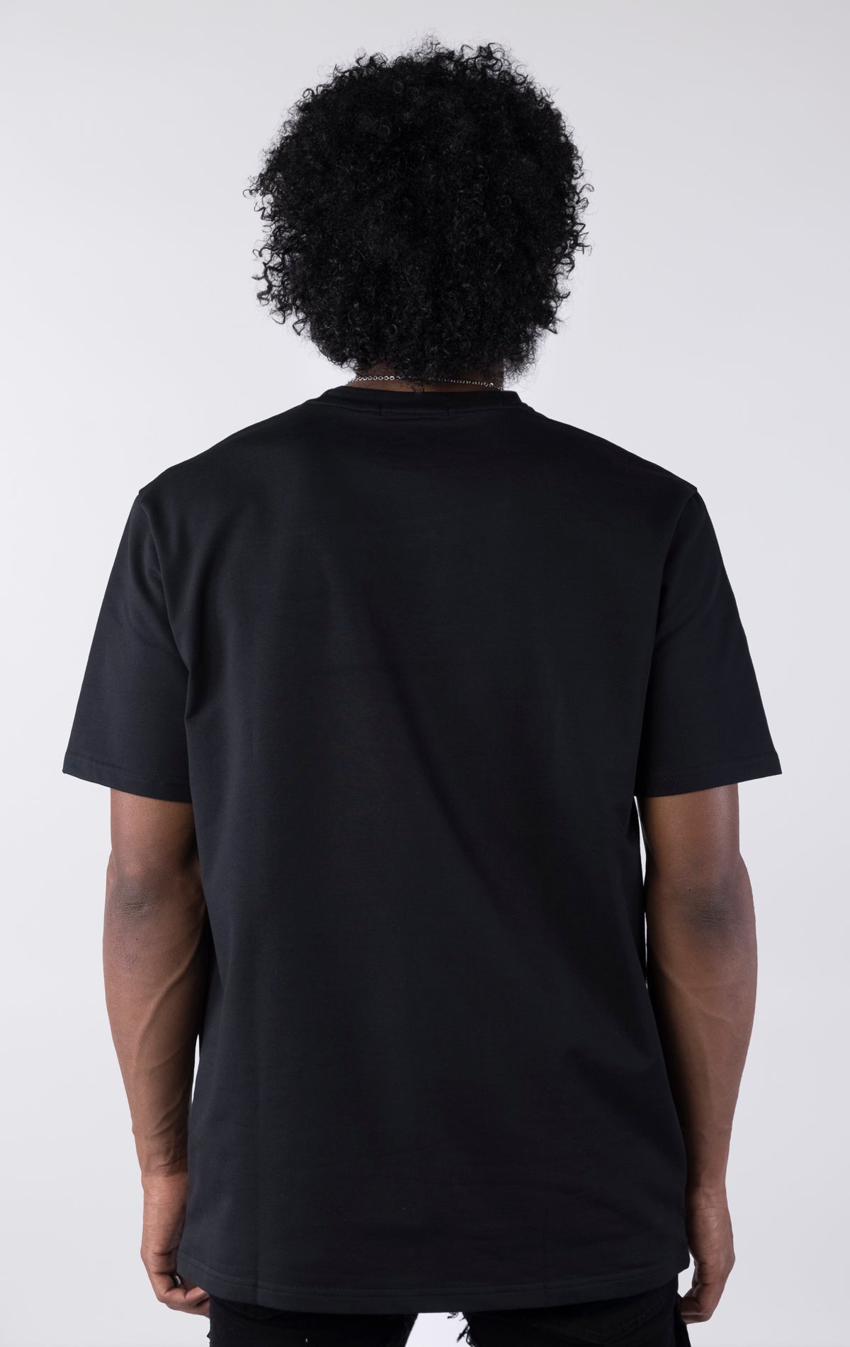 Person wearing a black t-shirt against a white background