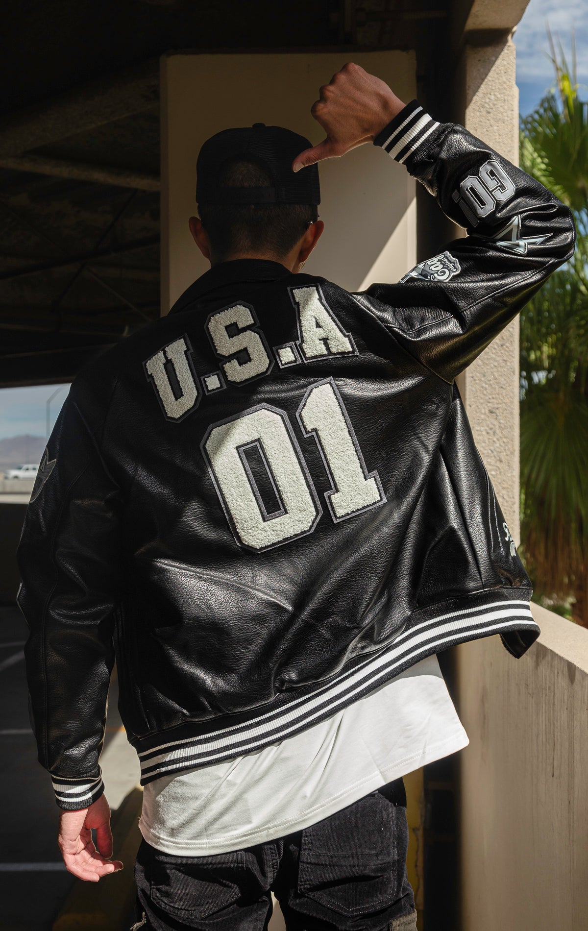 Black U.S.A. Varsity Jacket with patches, zip-up front, and quilted lining