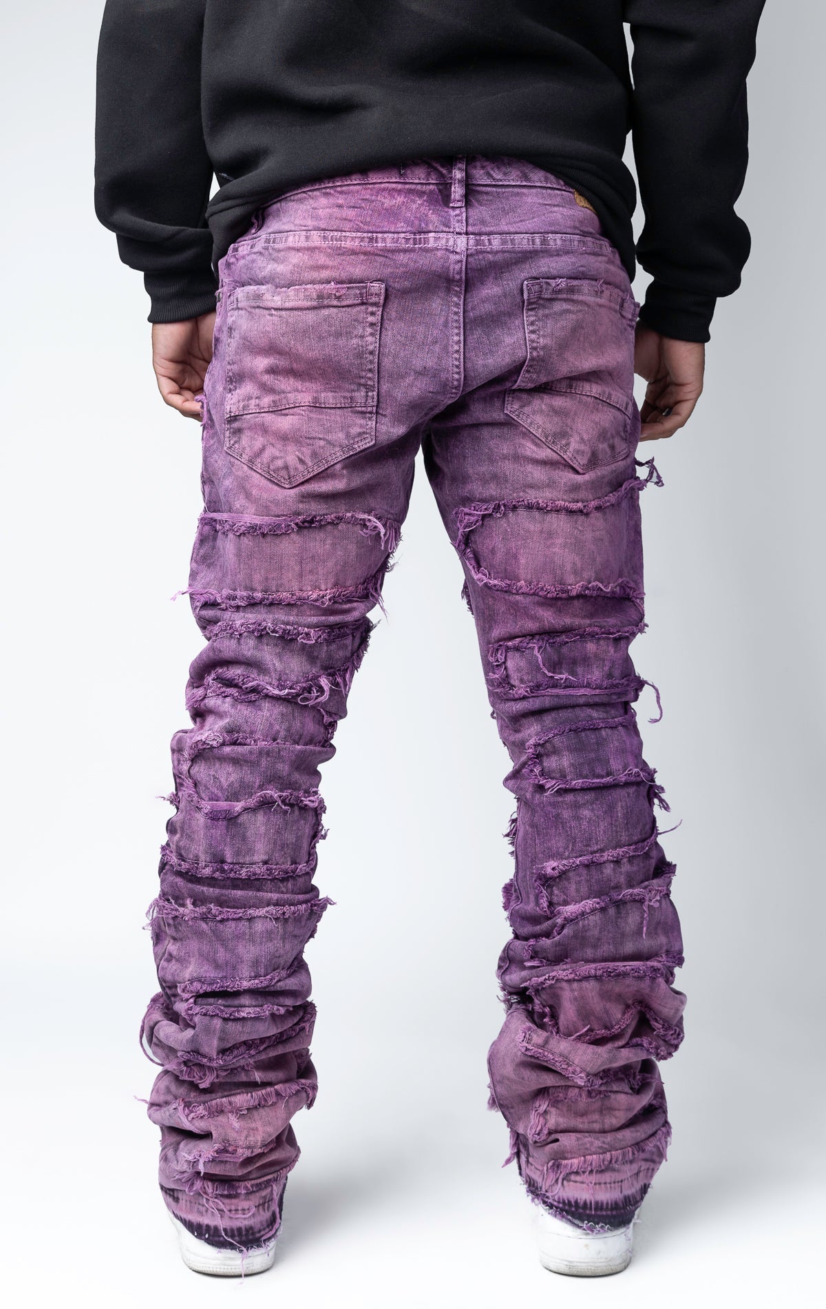 Blush distressed and stacked flare jeans featuring an ombre wash and ripped details