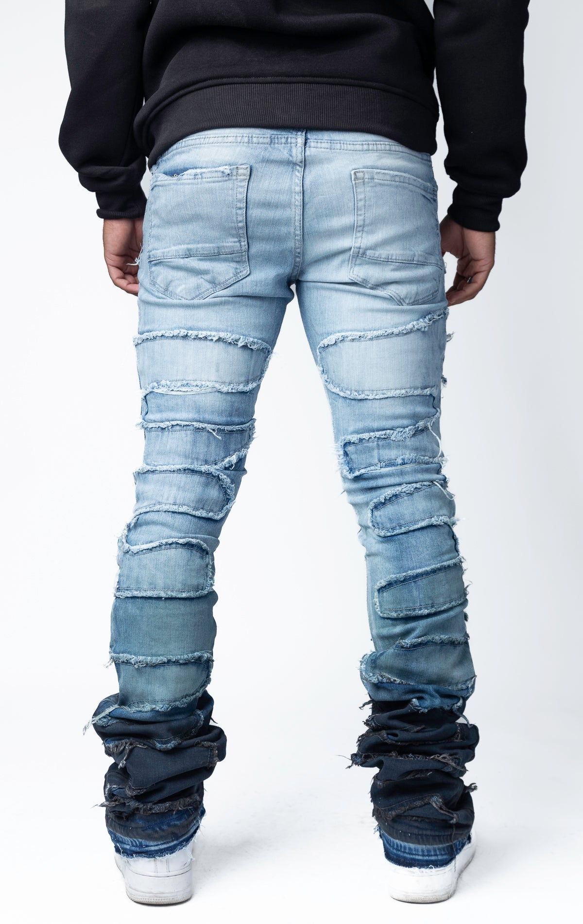 Blue distressed and stacked flare jeans featuring an ombre wash and ripped details