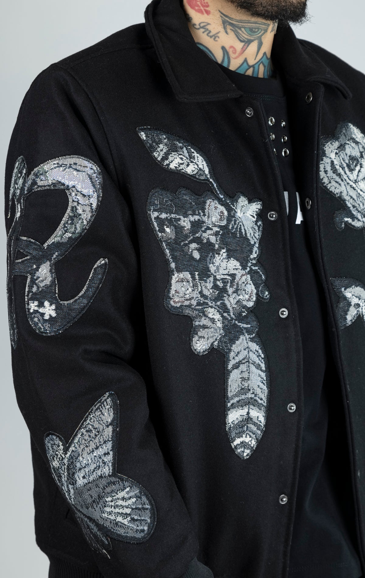 Rose Black White Varsity Jacket. 50% Polyester, 50% Wool. Features varsity tapestry patches