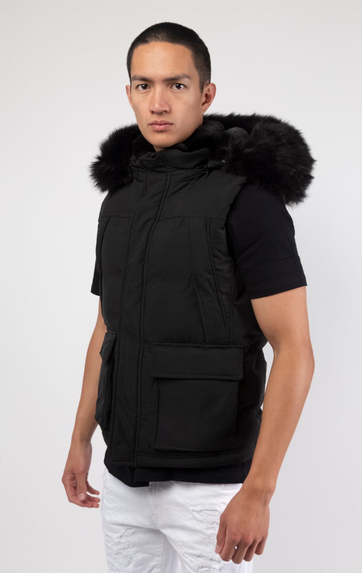 Black Faux fur-lined hooded jacket made of a water-resistant polyester shell featuring a removable hood with a removable faux fox fur trim. The hood and front of the jacket are lined with faux rabbit fur for superior warmth. The jacket has JC branded zipp