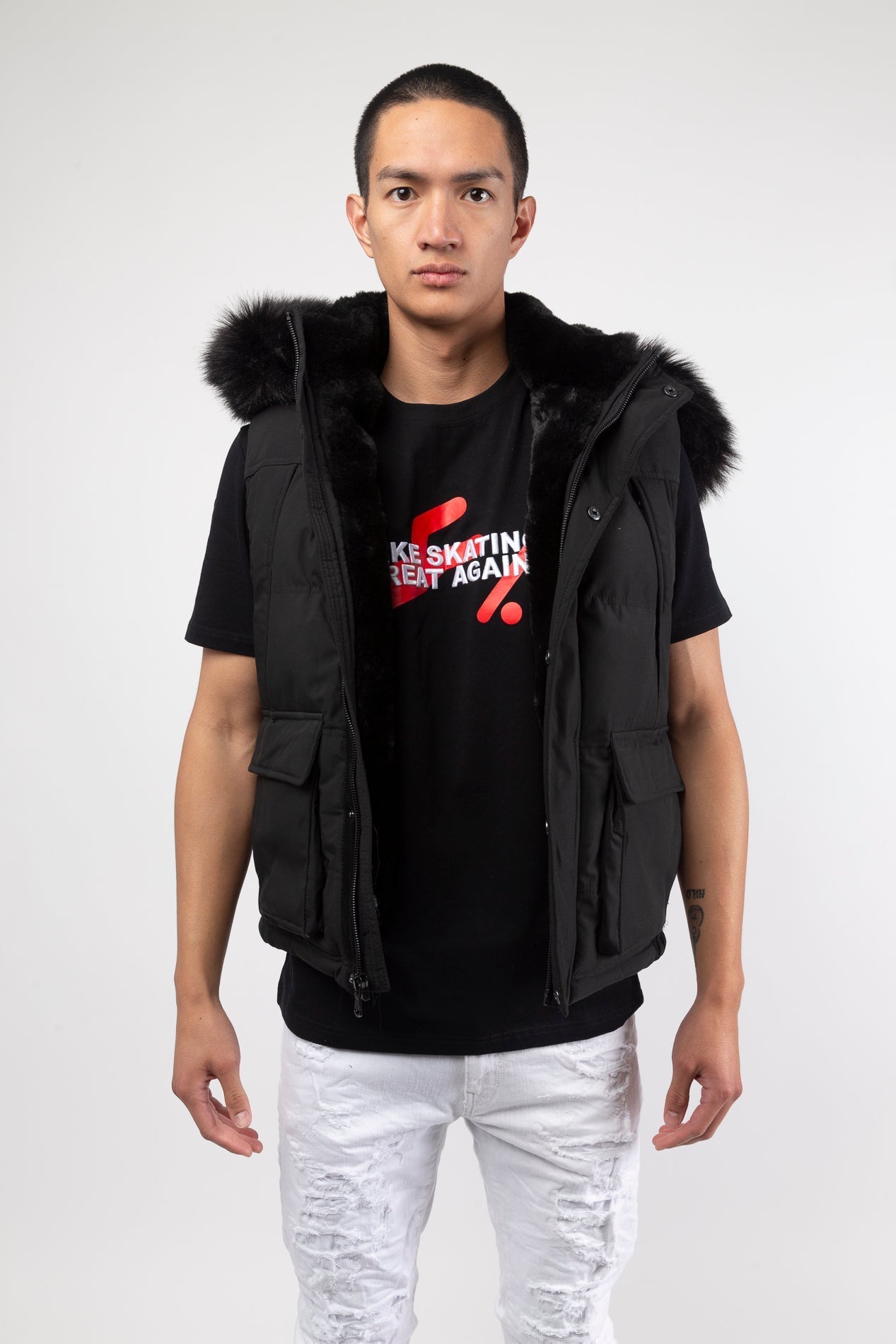 Black Faux fur-lined hooded jacket made of a water-resistant polyester shell featuring a removable hood with a removable faux fox fur trim. The hood and front of the jacket are lined with faux rabbit fur for superior warmth. The jacket has JC branded zipp