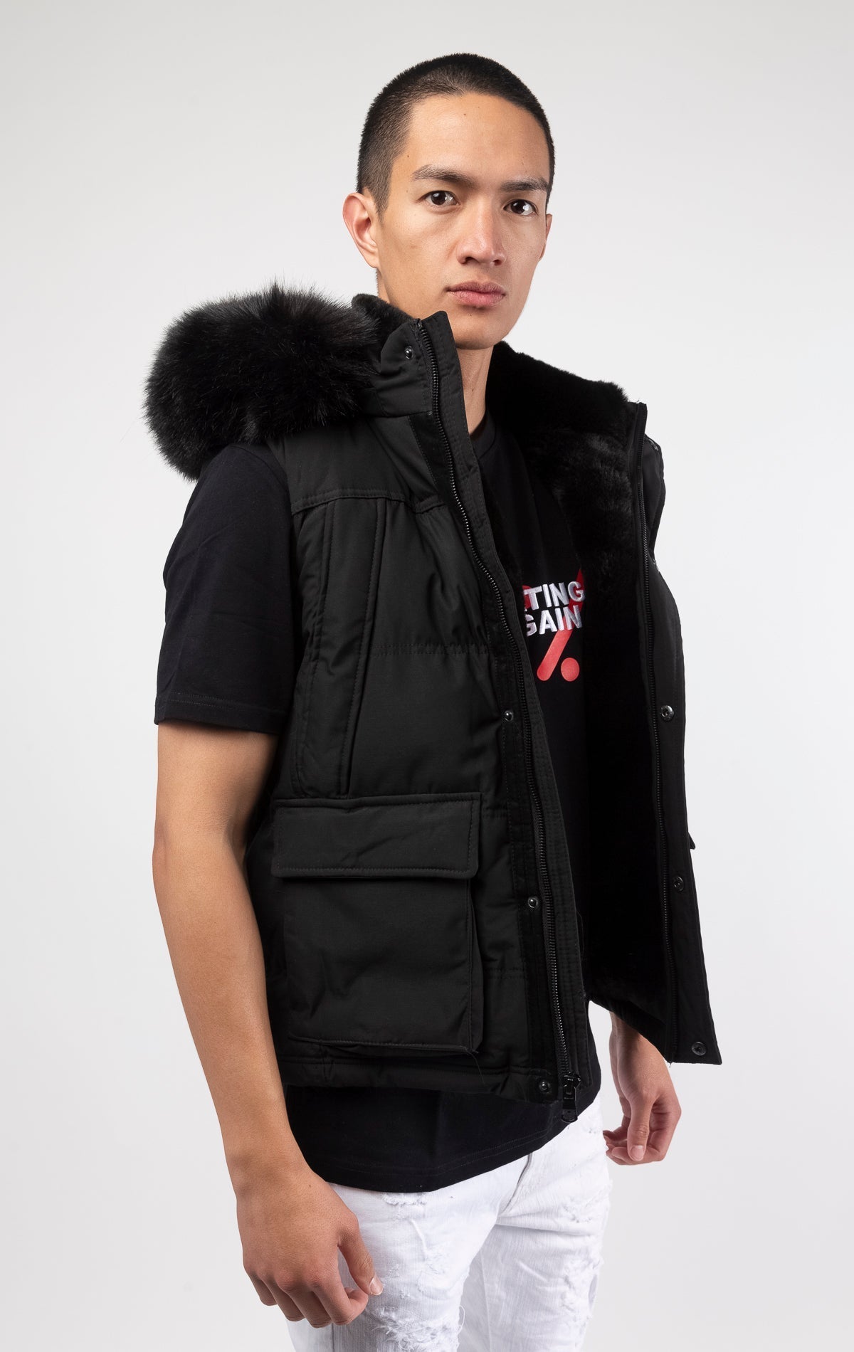 Black Faux fur-lined hooded jacket made of a water-resistant polyester shell featuring a removable hood with a removable faux fox fur trim. The hood and front of the jacket are lined with faux rabbit fur for superior warmth. The jacket has JC branded zipp