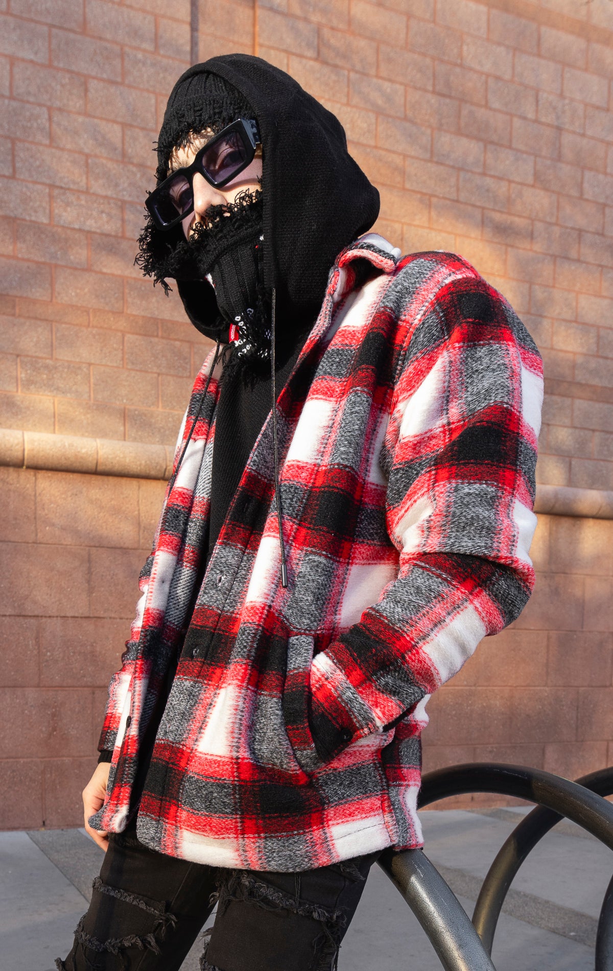 Model wearing Red, white and black oversized button up shirt made from soft, felted fabric