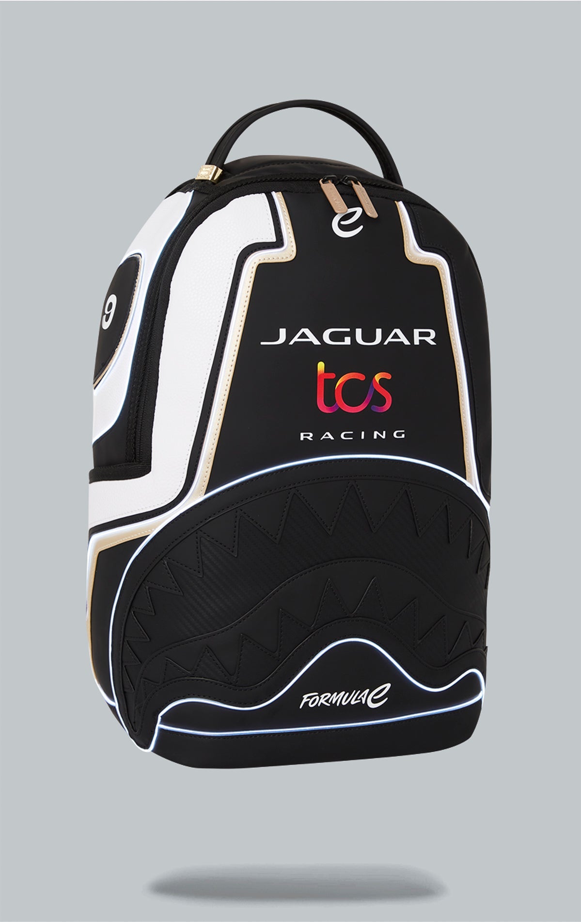 Sprayground x Formula E Jaguar backpack with built-in LED lights. Black water-resistant PVC backpack with Formula E Jaguar design. Includes laptop compartment, organizer pocket, and USB cable for charging. Note: Lithium battery inside, check with airline