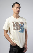 Stylish off white T-shirt featuring a motivational 'Young, Rich, and Lucky' slogan