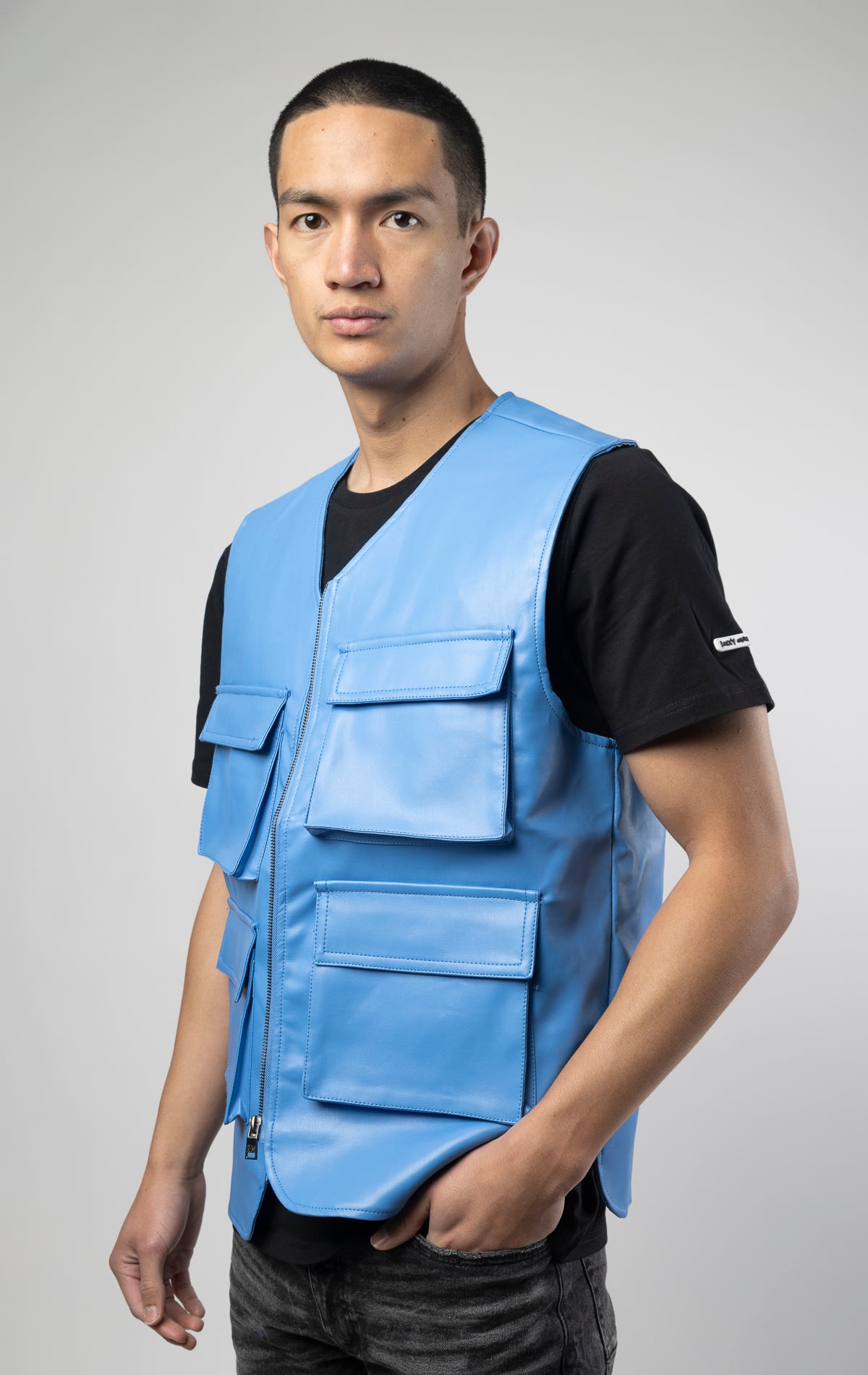 Blue faux leather cargo vest crafted from 100% PU, durable and cruelty-free. Featuring a 100% Polyester Linin.