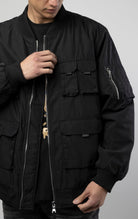 Men's utility bomber jacket with 5 pockets on the front (Velcro, zip, and snap closure), ribbed collar and cuffs, as well as a sleeve pocket 