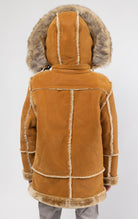 Cognac jacket lined with plush faux shearling throughout the body and sleeves. It also features shearling-accented pockets, a horn toggle front closure, and vegan suede straps with a buckle at the neck. For added convenience, a detachable faux fox fur hoo