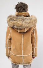 Praline jacket lined with plush faux shearling throughout the body and sleeves. It also features shearling-accented pockets, a horn toggle front closure, and vegan suede straps with a buckle at the neck. For added convenience, a detachable faux fox fur ho