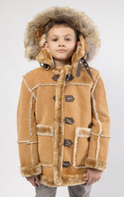 Praline jacket lined with plush faux shearling throughout the body and sleeves. It also features shearling-accented pockets, a horn toggle front closure, and vegan suede straps with a buckle at the neck. For added convenience, a detachable faux fox fur ho