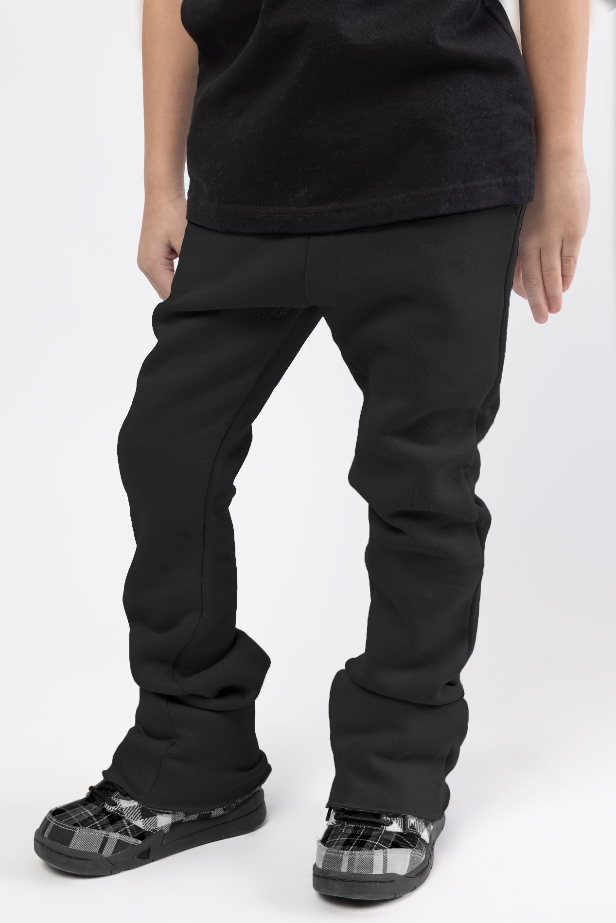 Black Stacked jogger for kids with flat draw cord, featuring two functional slash pockets at front and one patch pocket at back.